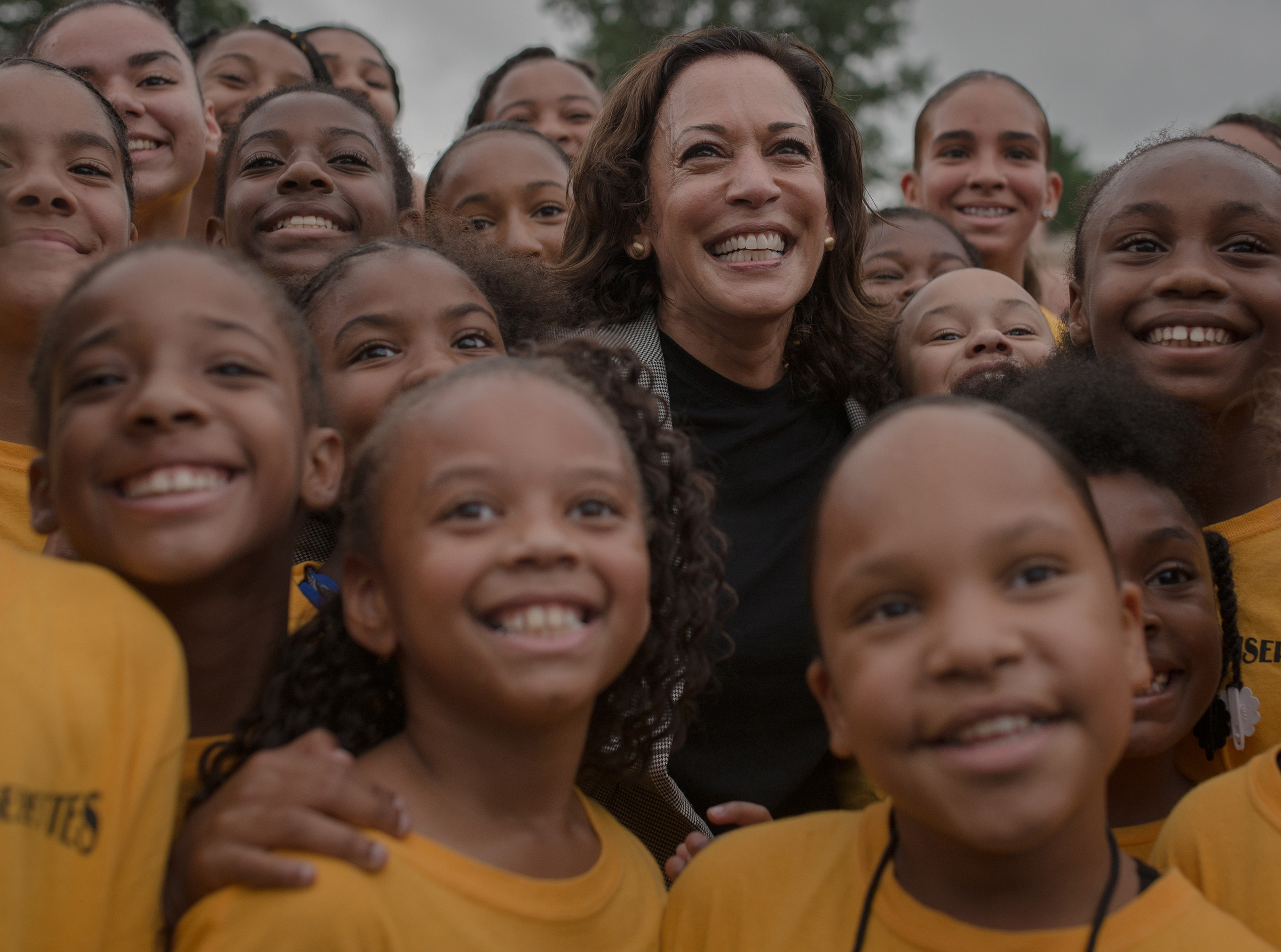 Harris takes takes a photo with the Isiserettes Drill and Drum Corps at a Des Moines Steakfry on Sept. 21, 2019.
