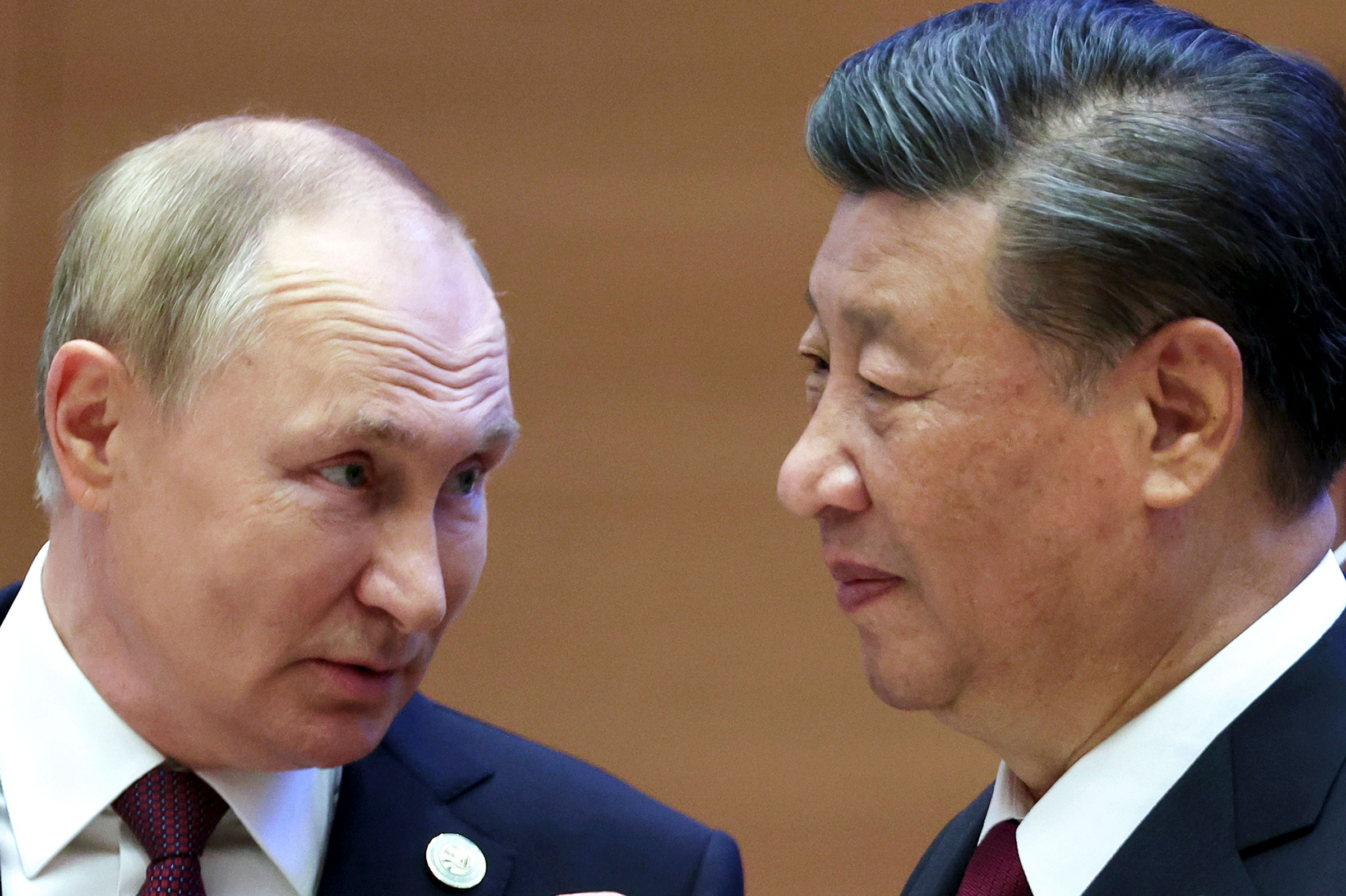 Russian President Vladimir Putin, left, speaks to Chinese President Xi Jinping during the Shanghai Cooperation Organization (SCO) summit in Samarkand, Uzbekistan on Sept. 16, 2022. 
