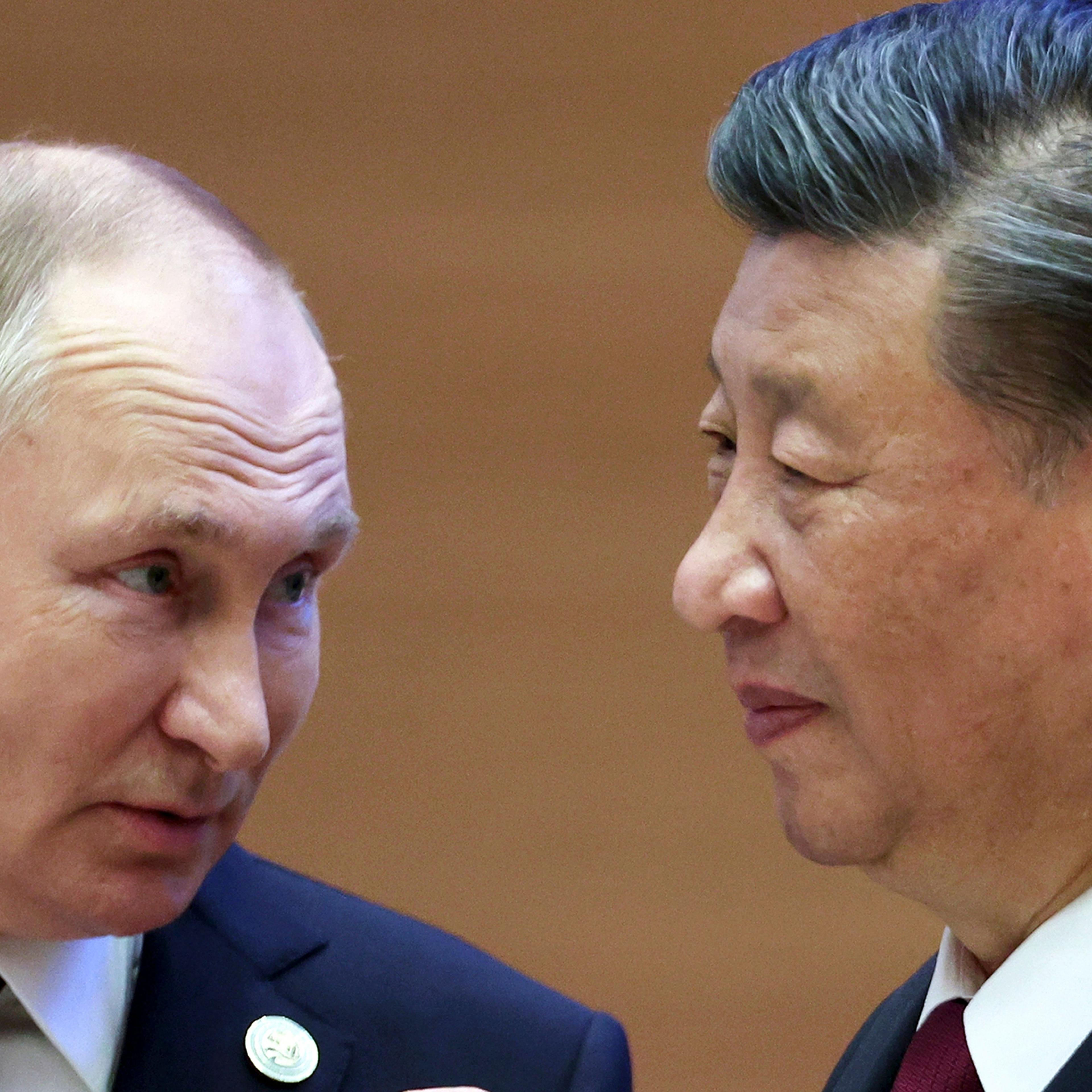 Russian President Vladimir Putin, left, speaks to Chinese President Xi Jinping during the Shanghai Cooperation Organization (SCO) summit in Samarkand, Uzbekistan on Sept. 16, 2022.