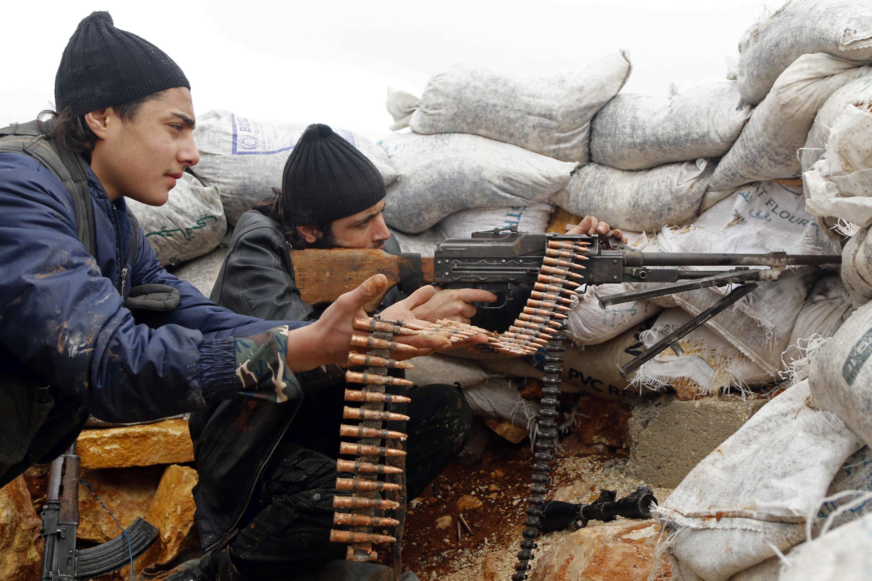 Rebel fighters fire a weapon on the al-Breij frontline, after what they said was an advance by them in the Manasher al-Hajr area where the forces of Syria's President Assad were stationed, in Aleppo