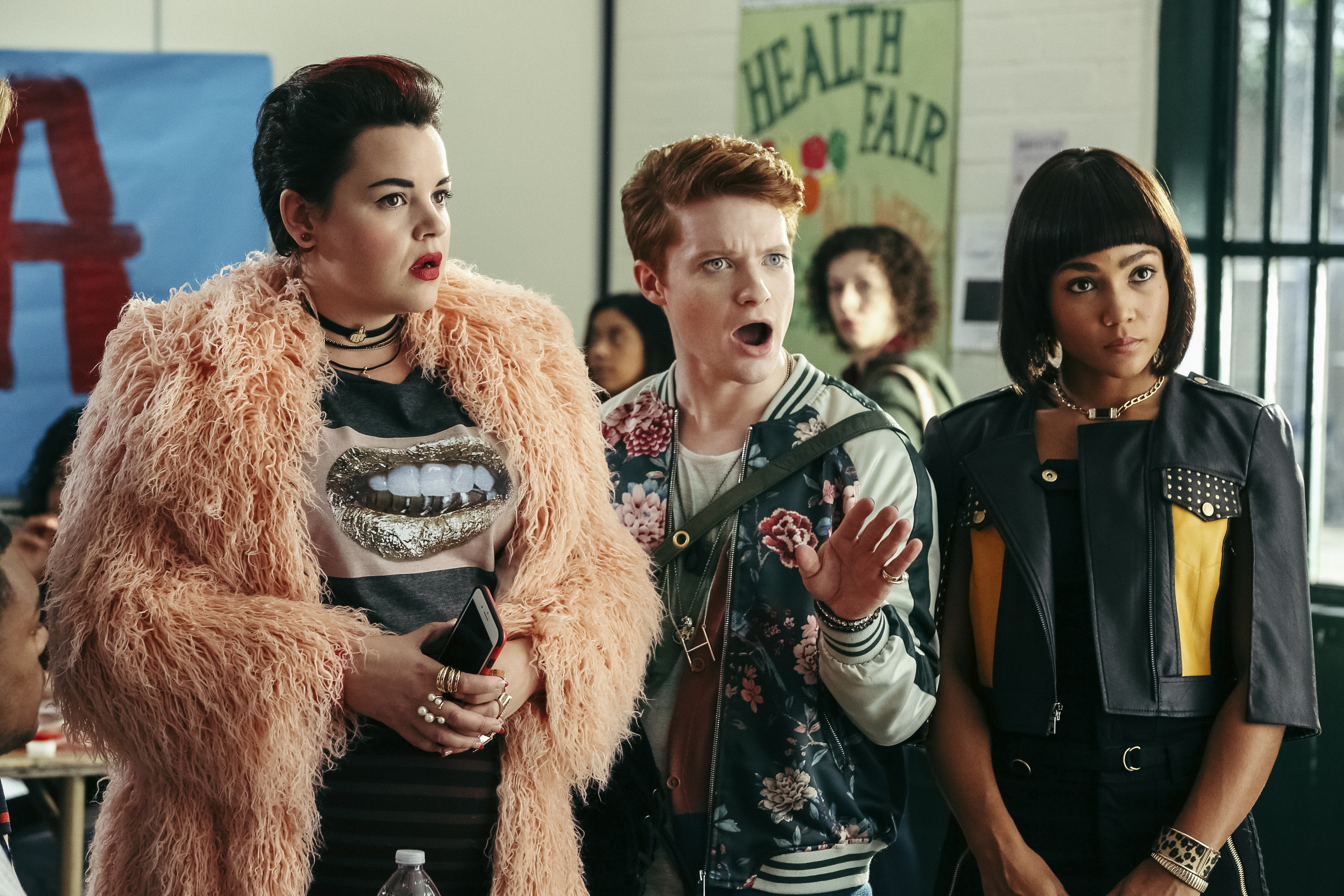 Heather Chander (l-Melanie Field) is the main "Heather" in charge at Westerburgh High. She's flanked by her Heather co-horts Heather Duke (c-Brendan Scannell) and Heather McNamara (r-Jasmine Mathews).  HEATHERS is a new pitch-black comedy series based on