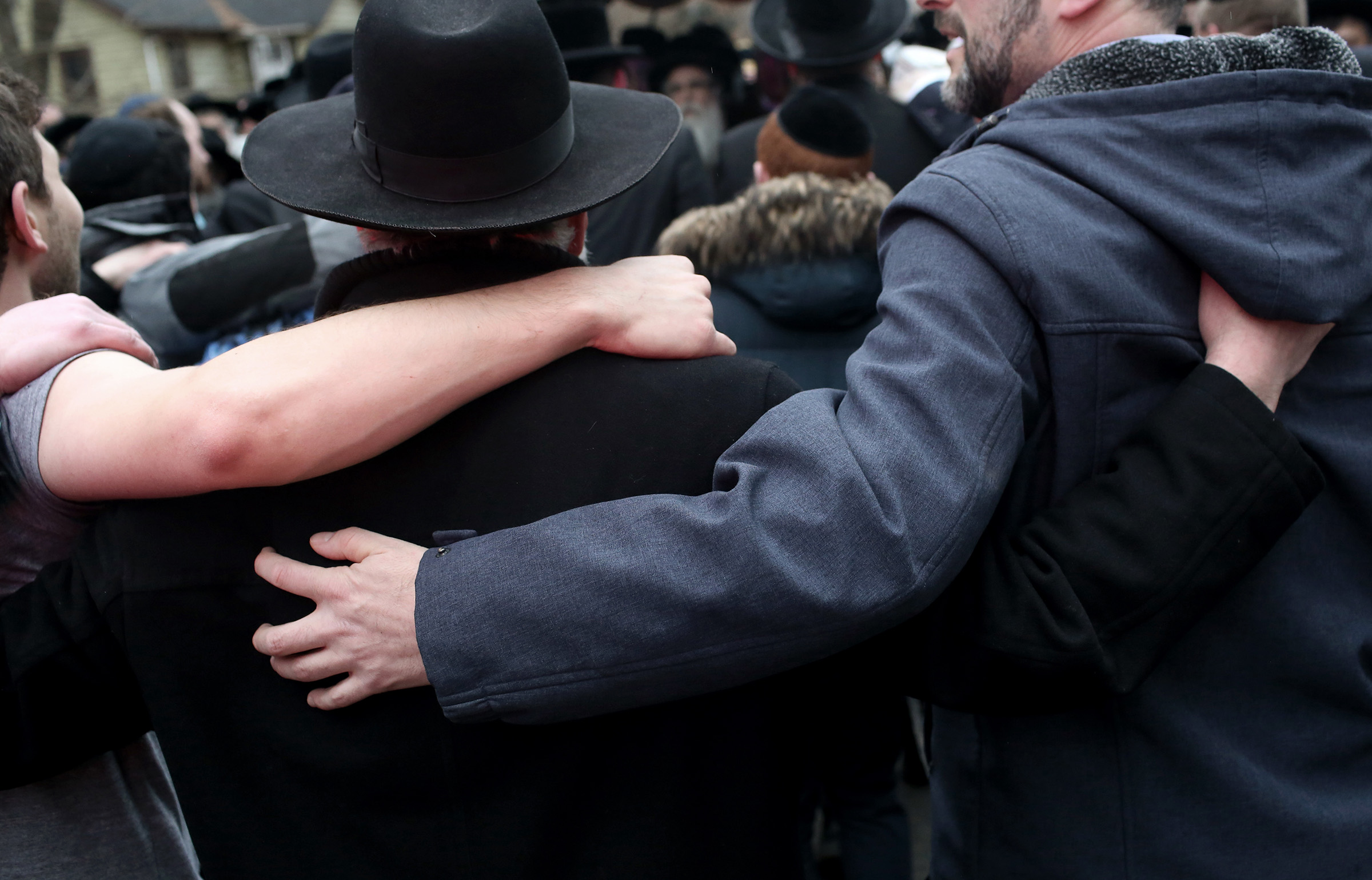 A gathering outside the home of Rabbi Chaim Rottenberg, where a man stabbed and wounded five people as they were gathering to light candles for Hanukkah, in Monsey, N.Y., Dec. 29, 2019.