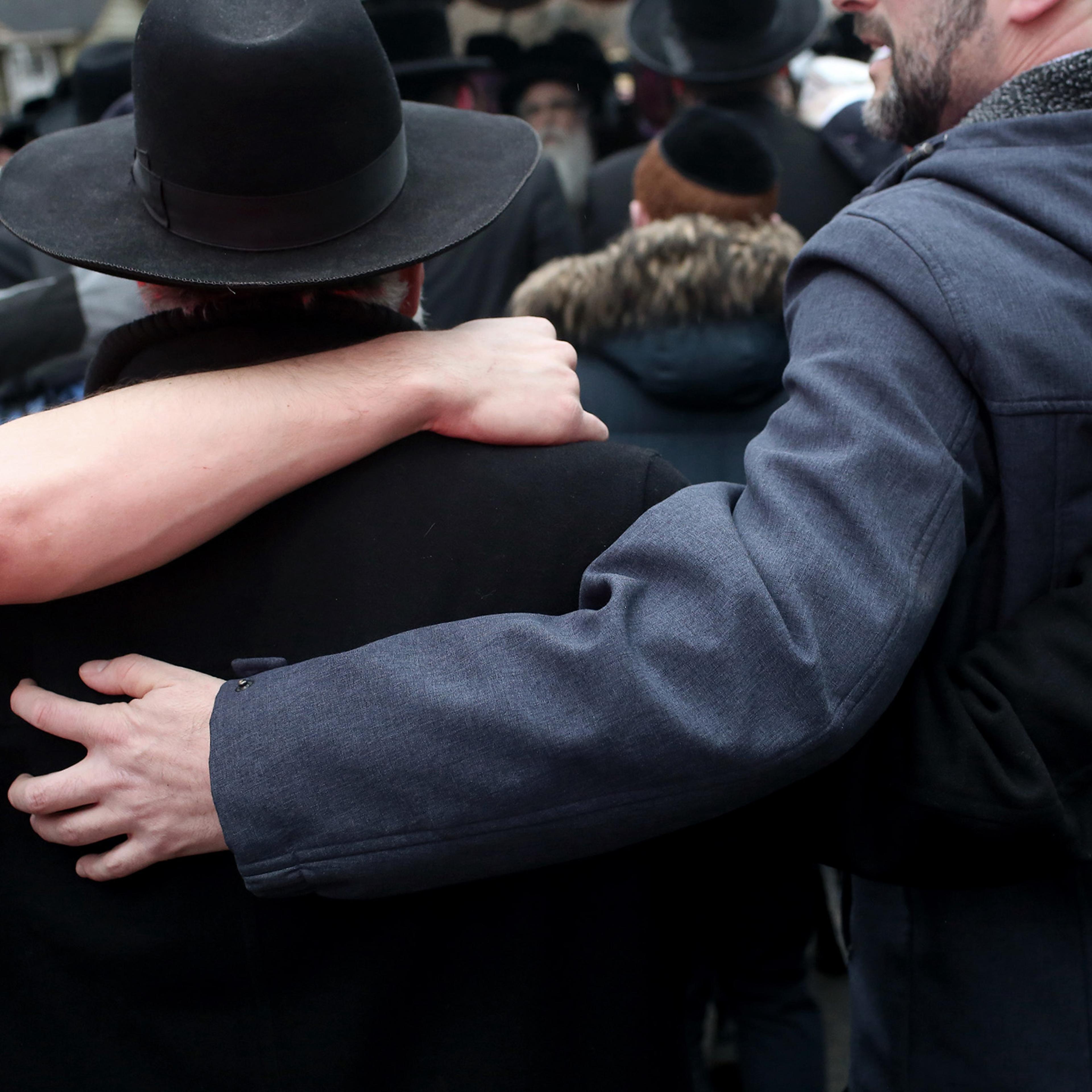 A gathering outside the home of Rabbi Chaim Rottenberg, where a man stabbed and wounded five people as they were gathering to light candles for Hanukkah, in Monsey, N.Y., Dec. 29, 2019.