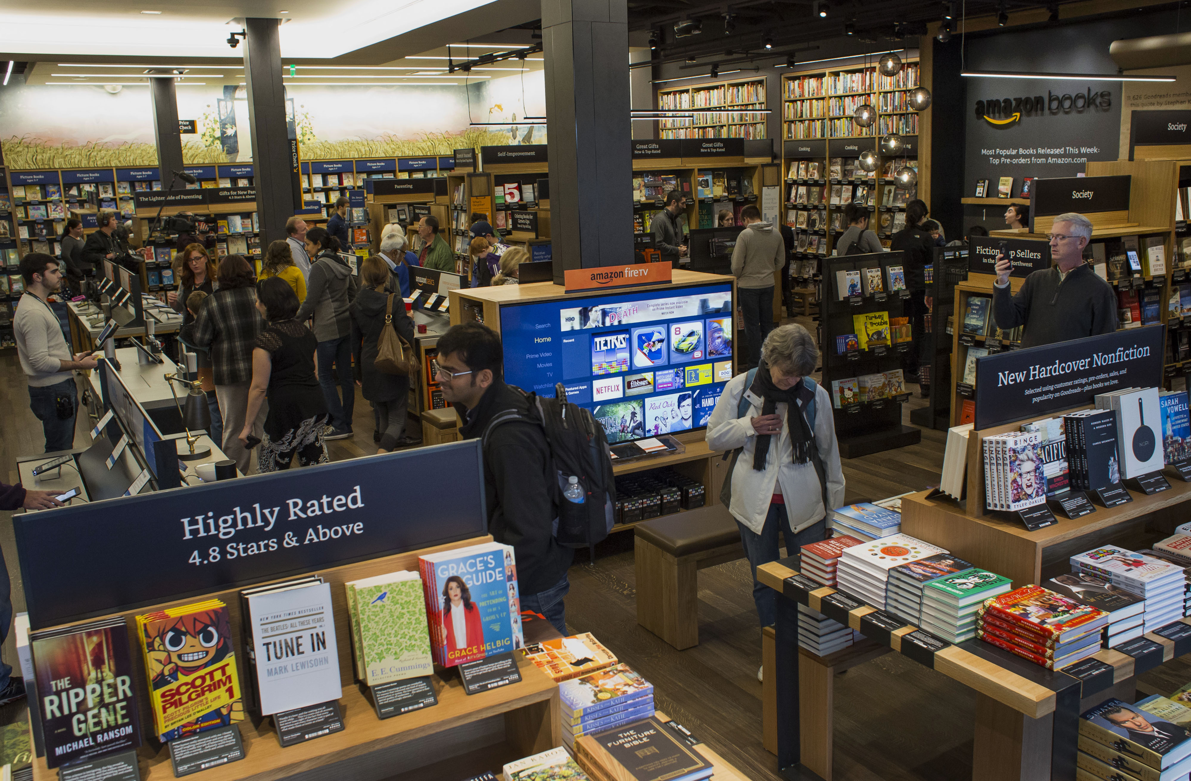 Customers shop inside Amazon Books in Seattle, Washington, on Tuesday, Nov. 3, 2015. The online retailer Amazon.com Inc. opened its first brick-and-mortar location in Seattle's upscale University Village mall. Photographer: Jasper Juinen/Bloomberg