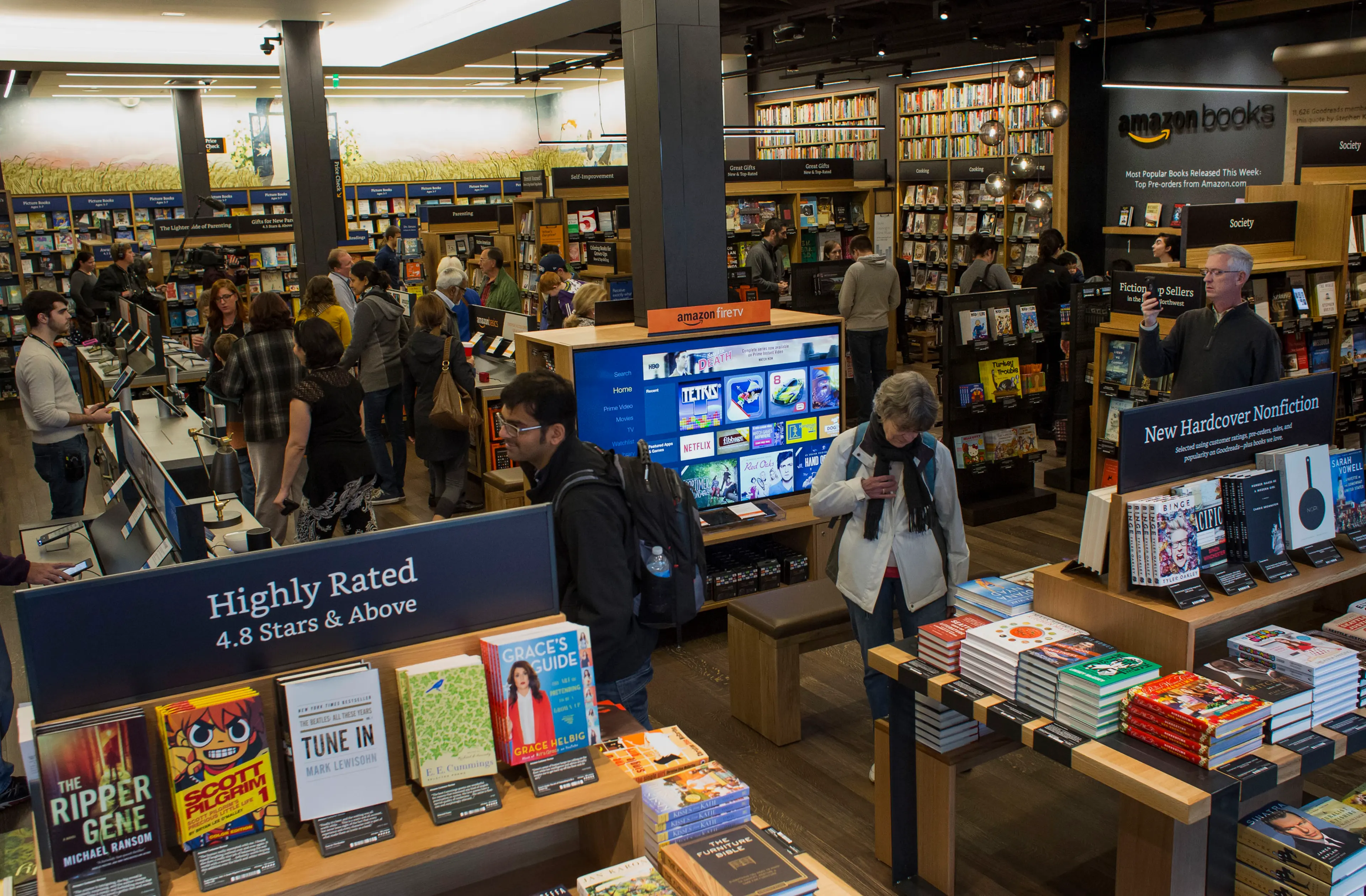 Customers shop inside Amazon Books in Seattle, Washington, on Tuesday, Nov. 3, 2015. The online retailer Amazon.com Inc. opened its first brick-and-mortar location in Seattle's upscale University Village mall. Photographer: Jasper Juinen/Bloomberg