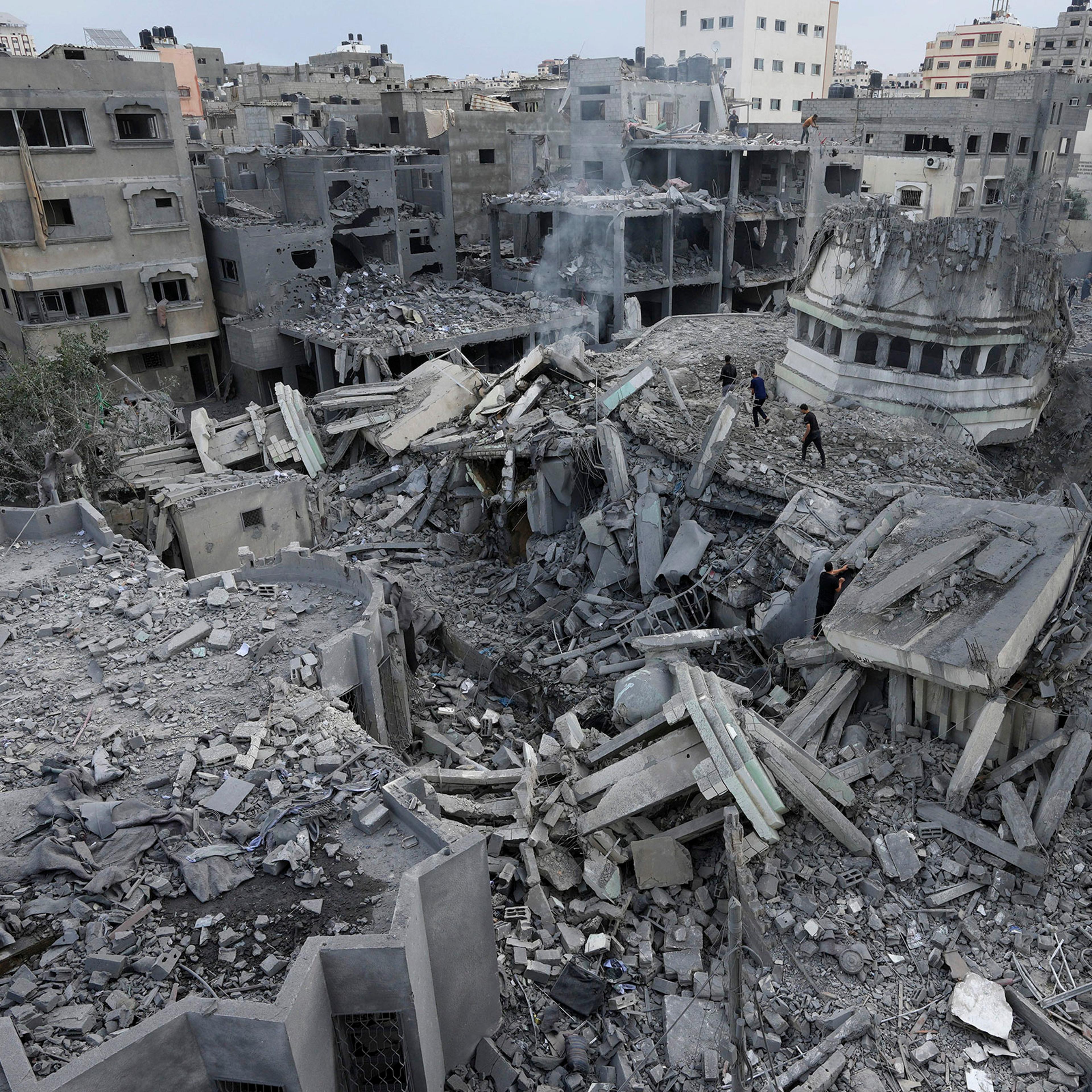 Palestinians inspect the rubble of the Yassin Mosque destroyed after it was hit by an Israeli airstrike at Shati refugee camp in Gaza City, Oct. 9, 2023.