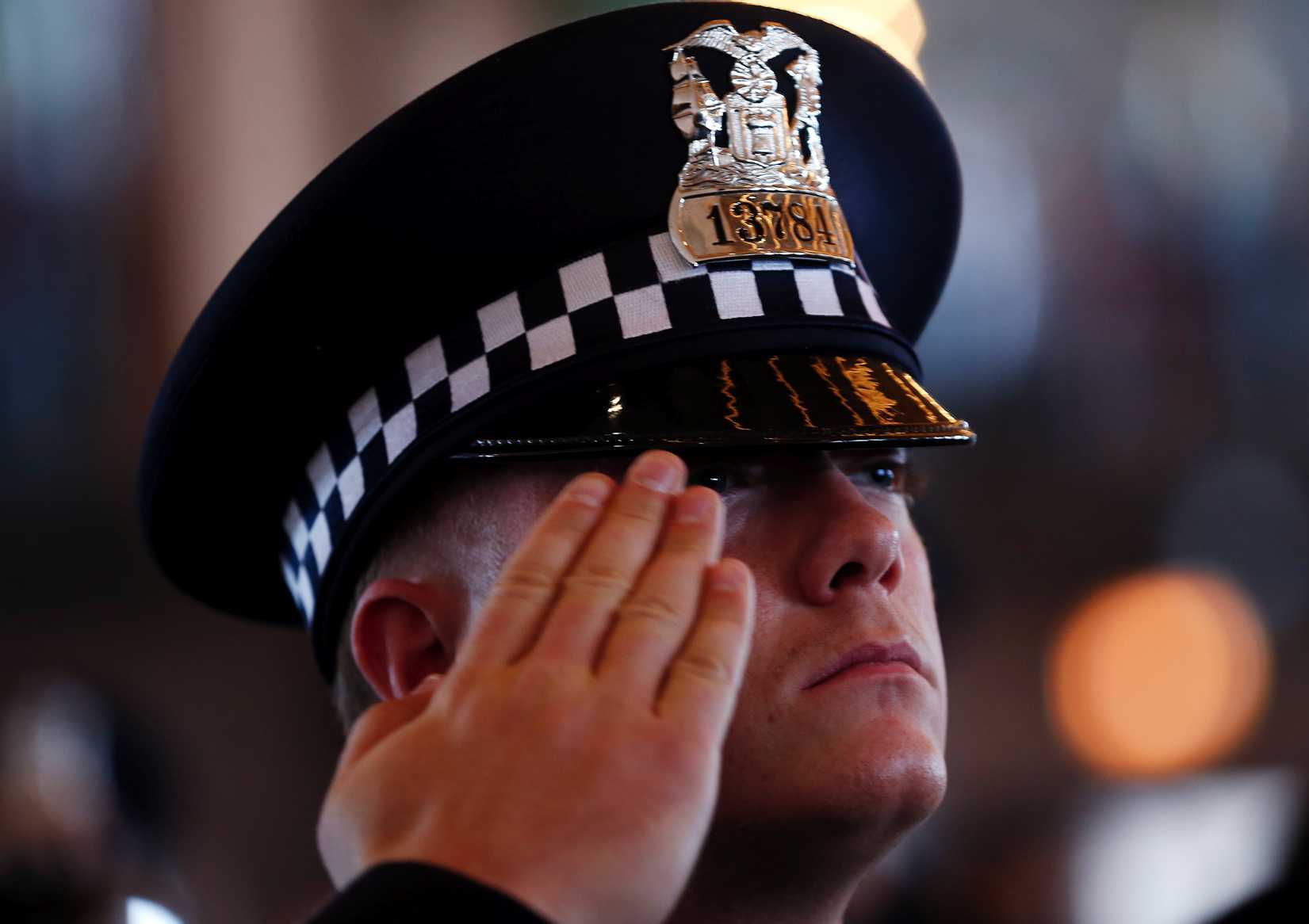 A Chicago Police Department recruit salutes during a graduation ceremony in Chicago, Illinois, April 21, 2014. 
