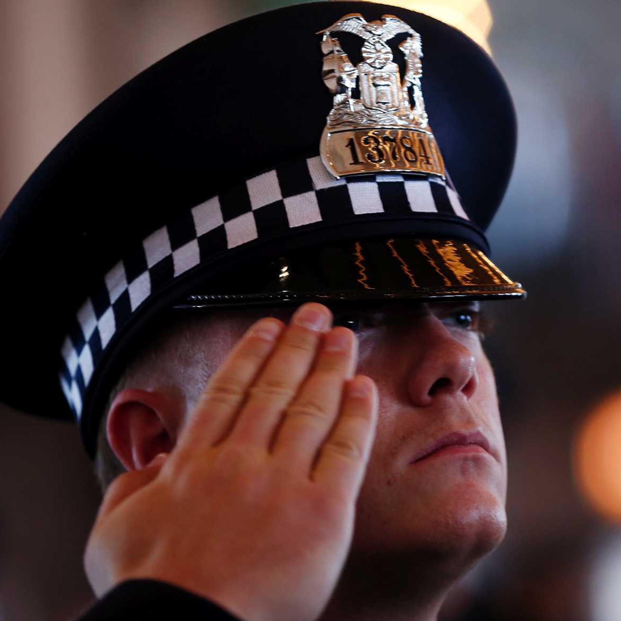 A Chicago Police Department recruit salutes during a graduation ceremony in Chicago, Illinois, April 21, 2014.