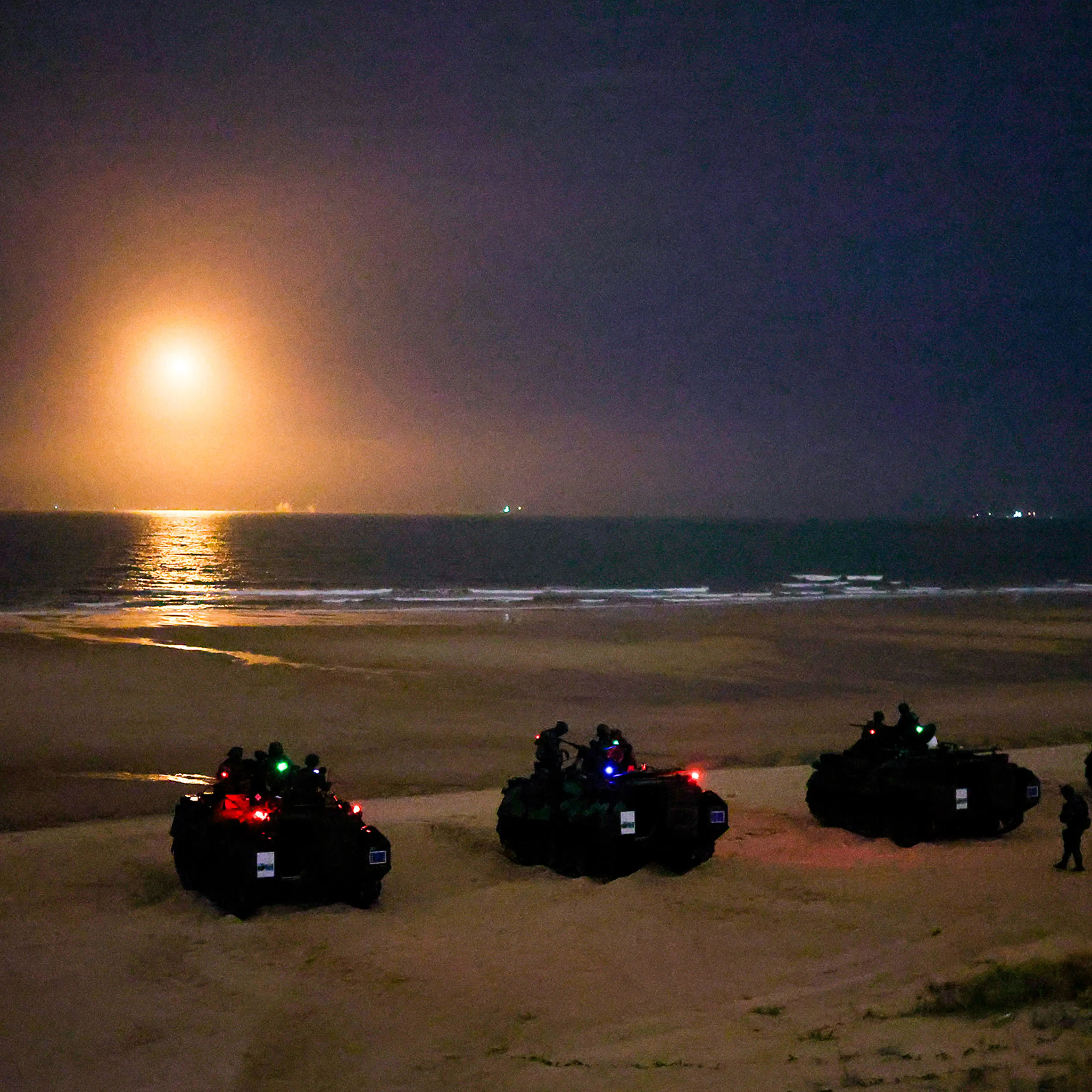 Armored vehicles mobilize during a live-ammunition drill in Taiwan on July 14, 2025.