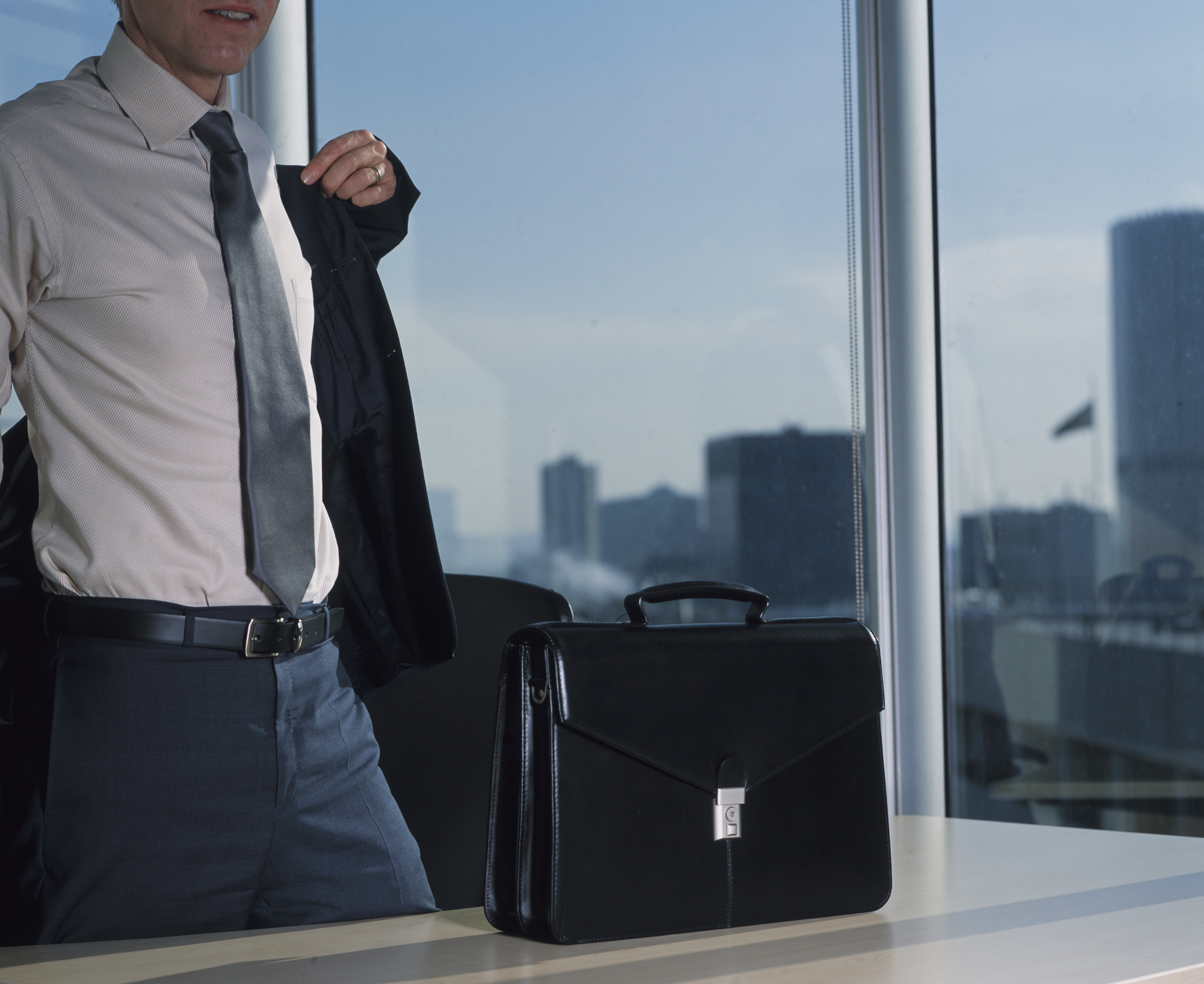 Businessman Putting Jacket on