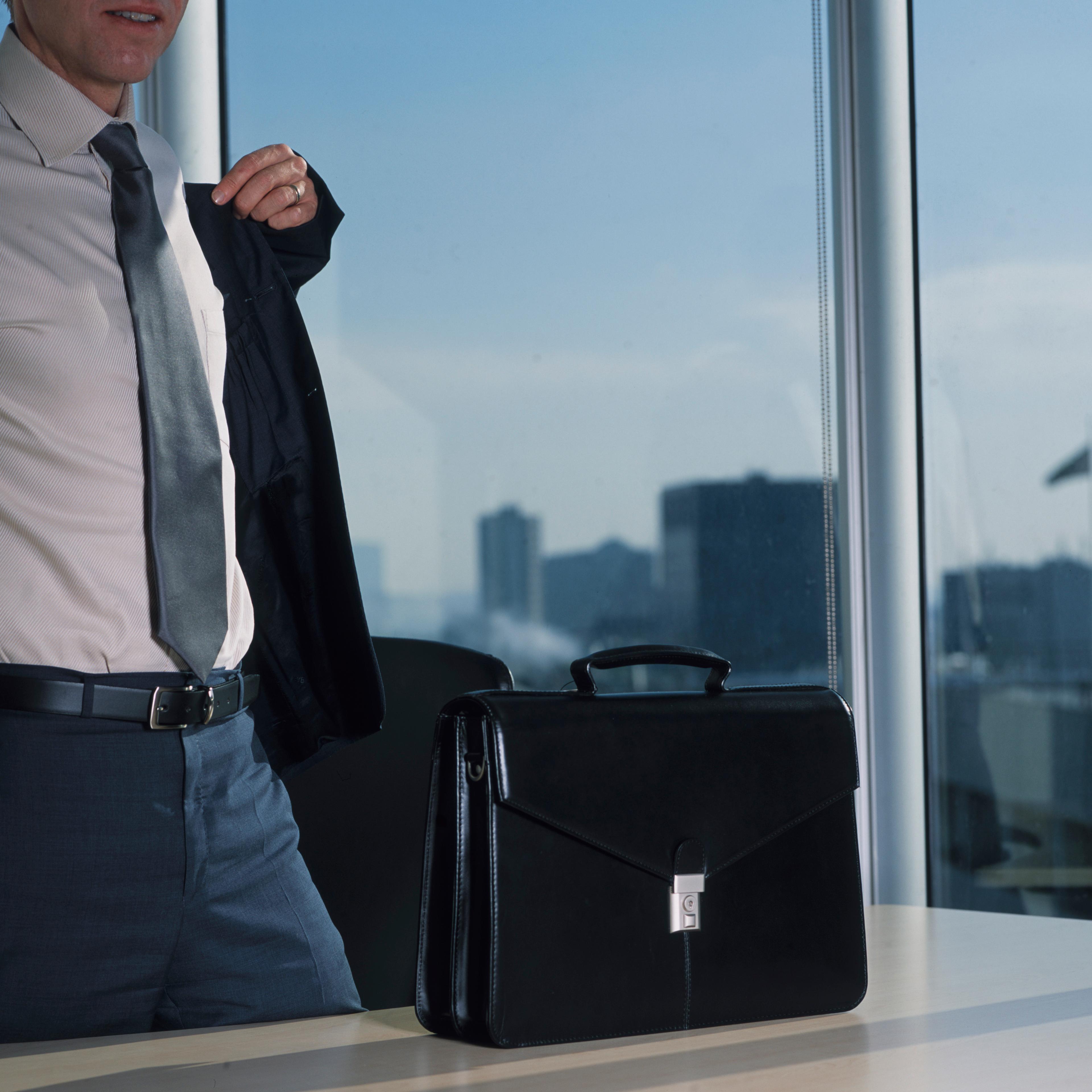 Businessman Putting Jacket on