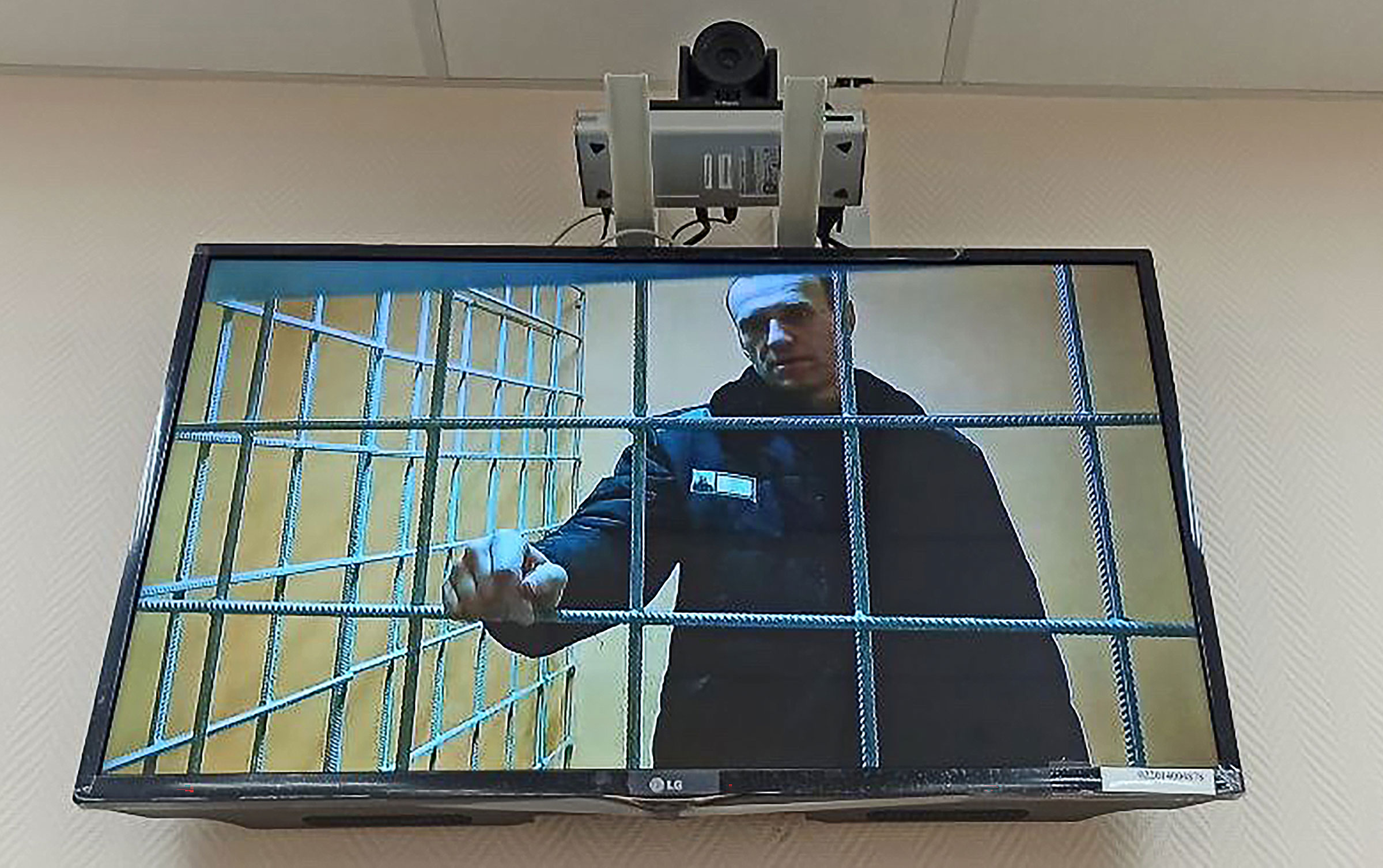Russian opposition activist Alexei Navalny is seen on the screen during a hearing at the Petushki District Court on January 17, 2022.