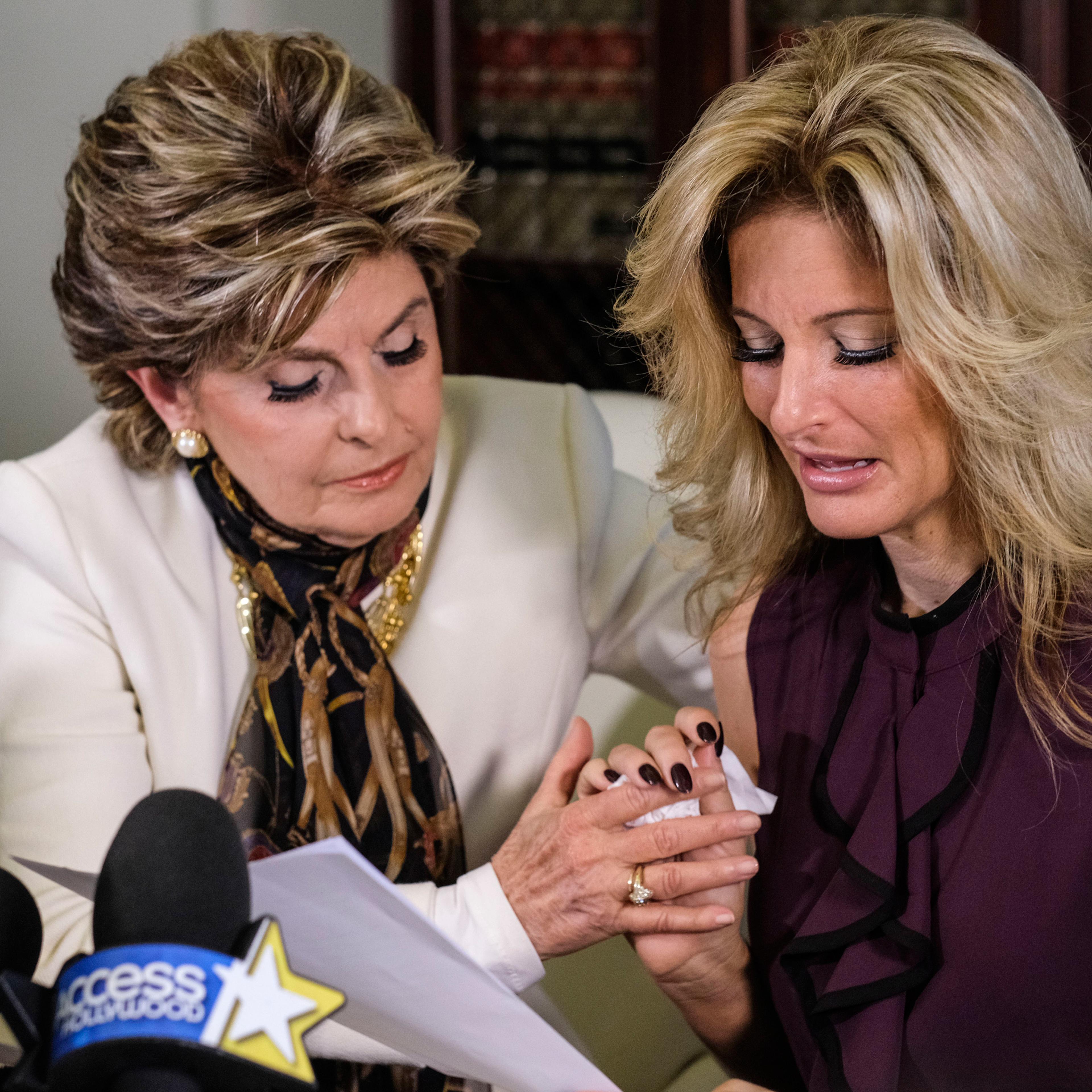 Attorney Gloria Allred, left, comforts Summer Zervos as Zervos reads a statement during a news conference in Los Angeles, Friday Oct. 14, 2016. Zervos, a former contestant on "The Apprentice" says Republican presidential candidate Donald Trump made unwan