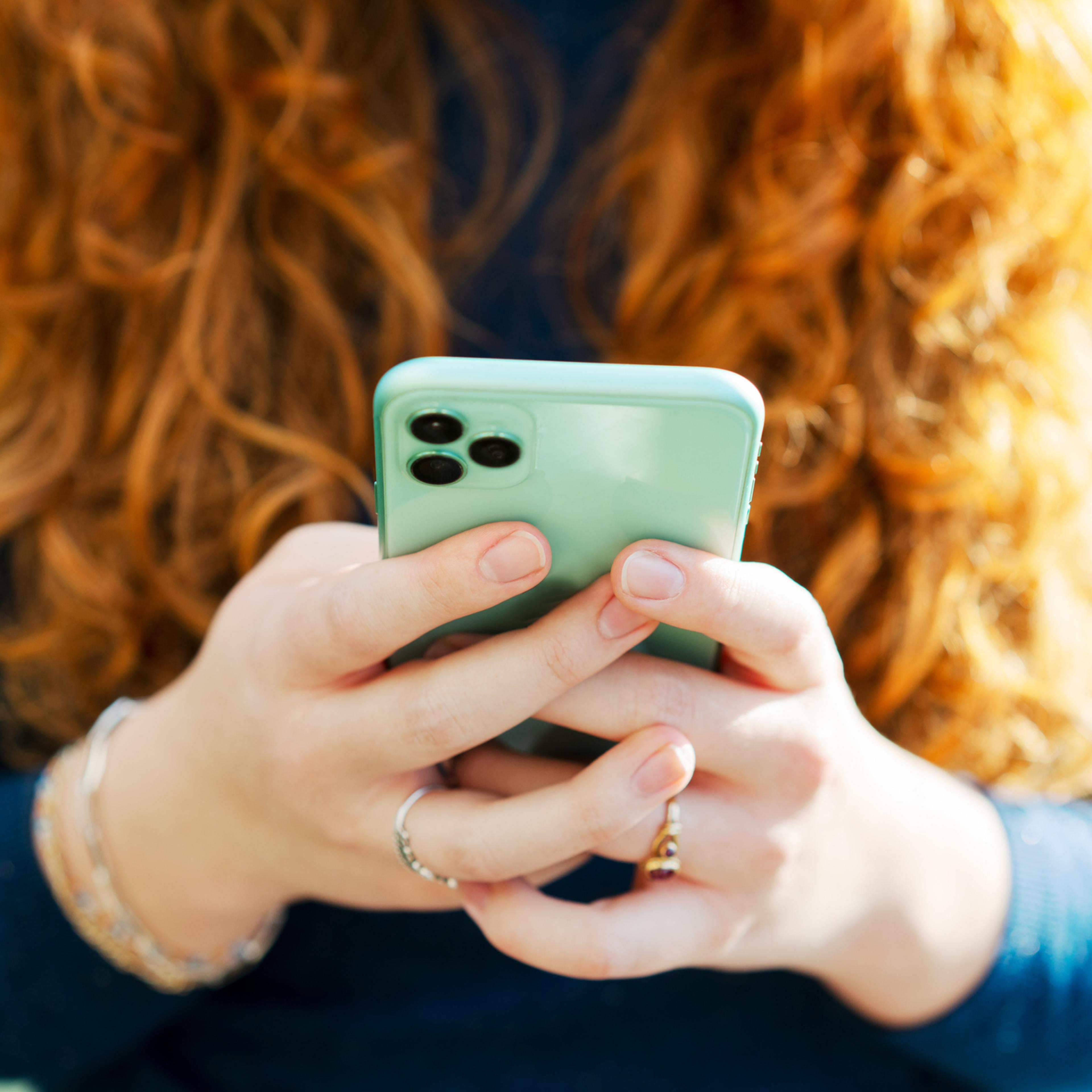Close up on woman using smart phone