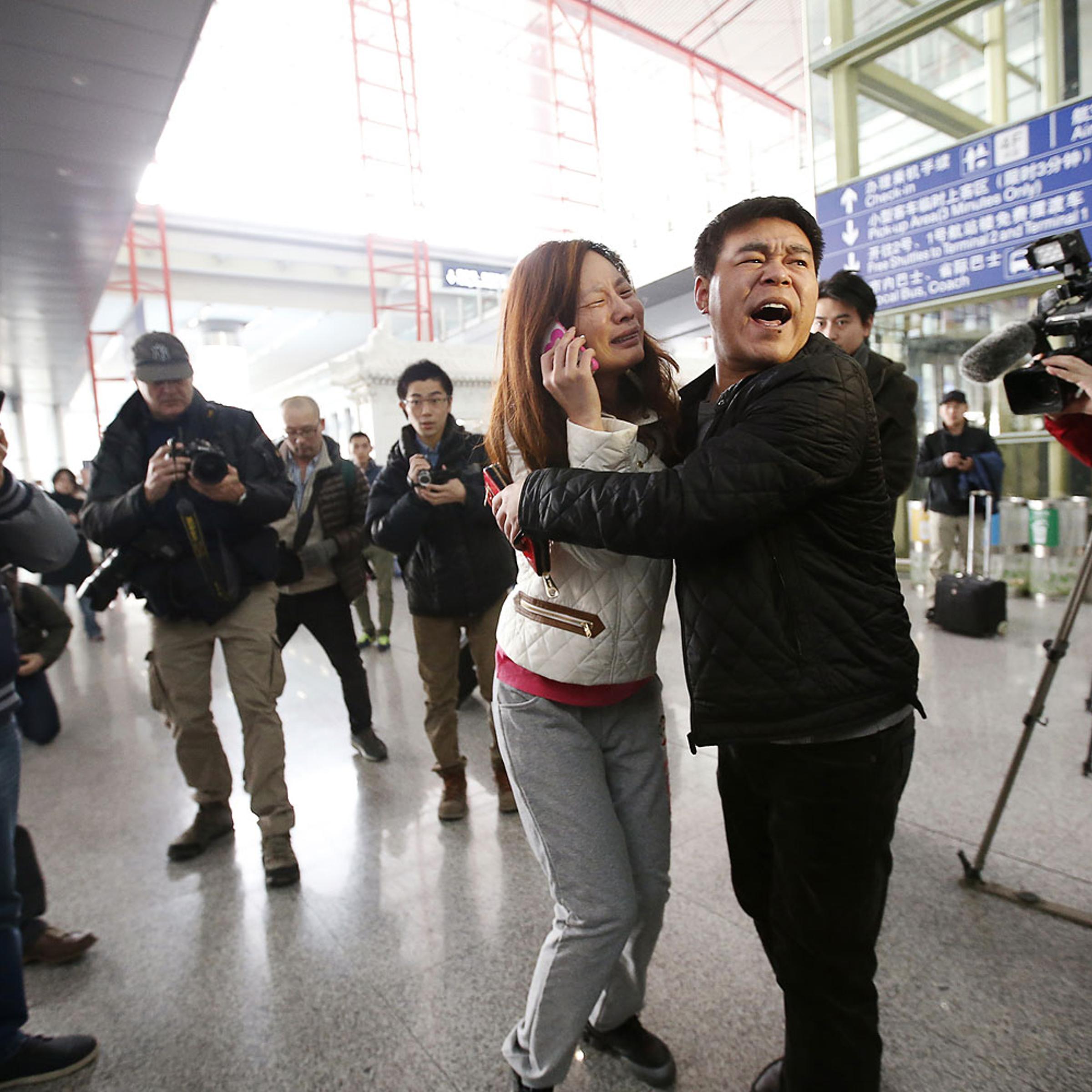 A relative of a passenger onboard Malaysia Airlines flight MH370 cries at the Beijing Capital International Airport