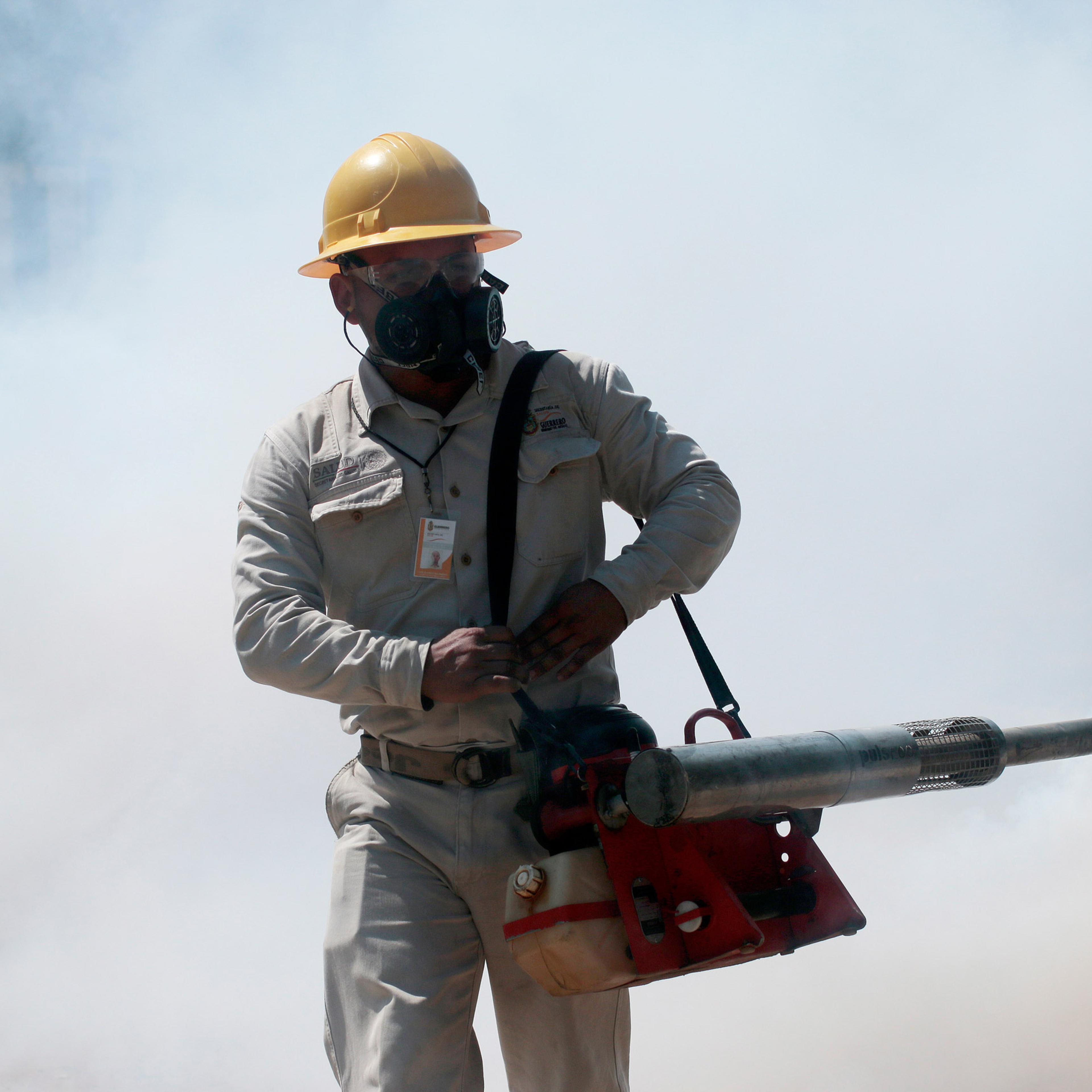 An employee of the Health Secretariat fumigates against the Aedes aegypti mosquito to prevent the spread of the Zika, Chikungunya and Dengue in Acapulco, Guerrero State, Mexico on February 2, 2016. AFP PHOTO/ Pedro PARDO / AFP / Pedro PARDO (Photo credit