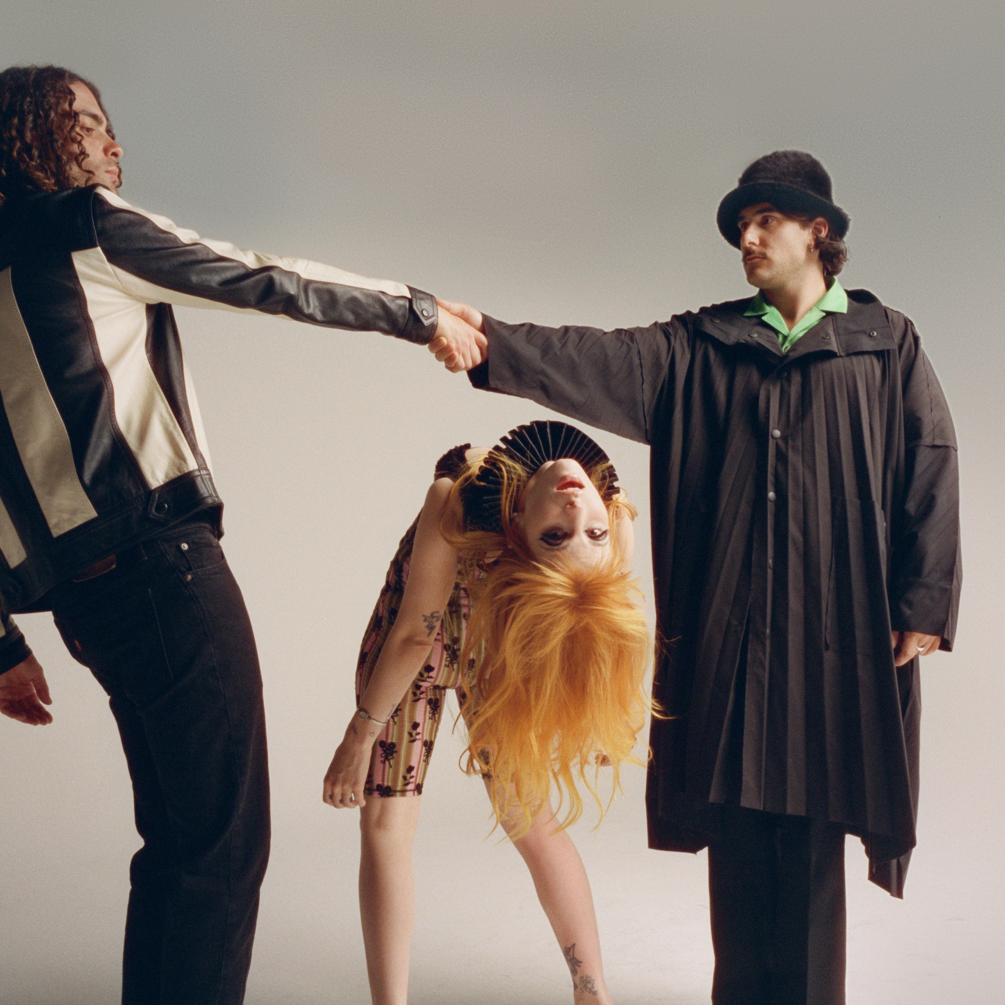 Taylor and Zac holding hands and Hayley does a backbend
