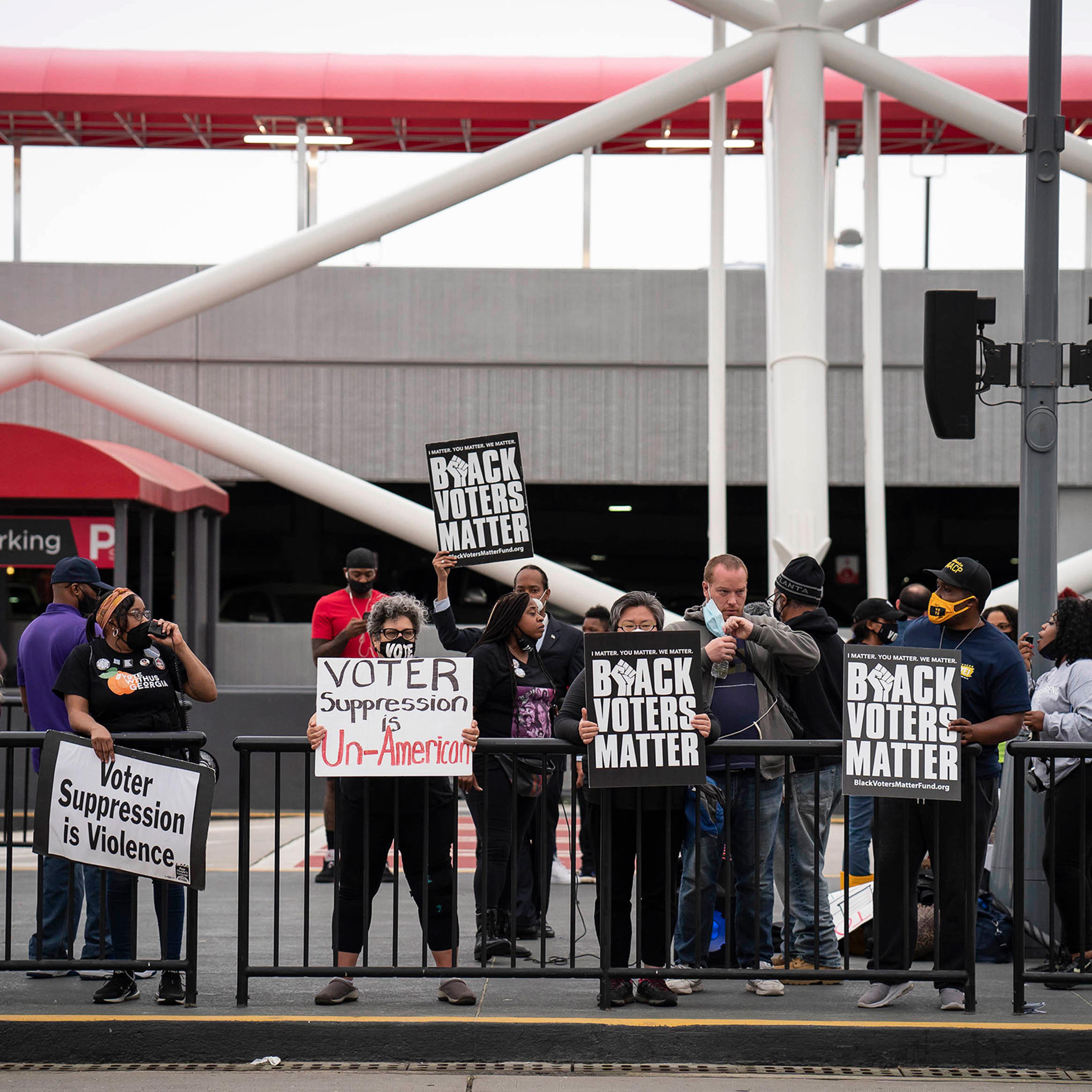 Voting-rights activists call for a boycott of Delta Air Lines during a protest at Hartsfield-Jackson Atlanta International Airport in Atlanta, March 25, 2021.