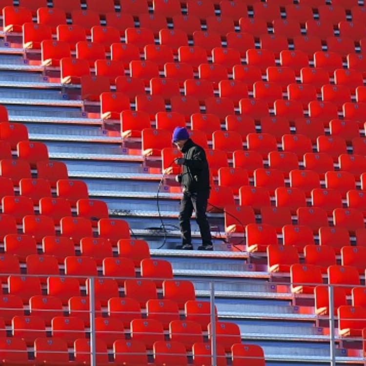 This picture taken on December 12, 2017 shows a South Korean worker setting up a cable at the Olympic Stadium, the venue of the opening and closing ceremony for the PyeongChang 2018 Winter Olympic Games, in Pyeongchang.