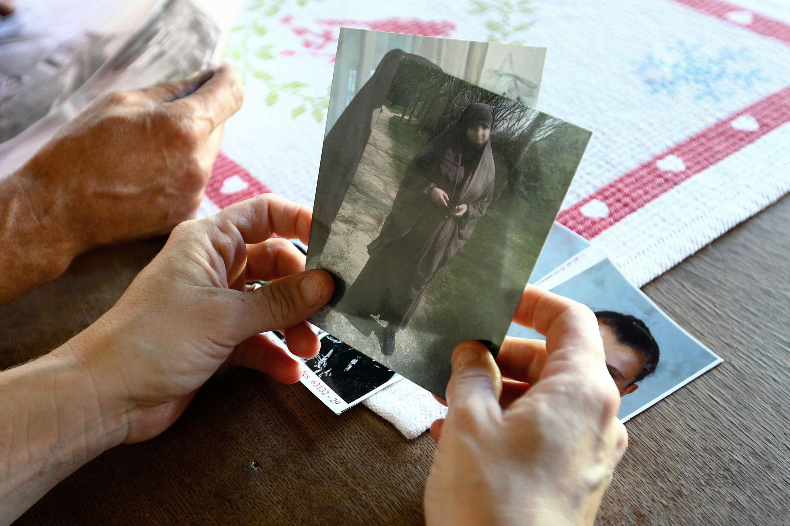 Severine Ali Mehenni holds pictures of her daughter Sahra dressed in a traditional Islamic robe, at her home in Lezignan Corbieres, France, Oct. 2, 2014.