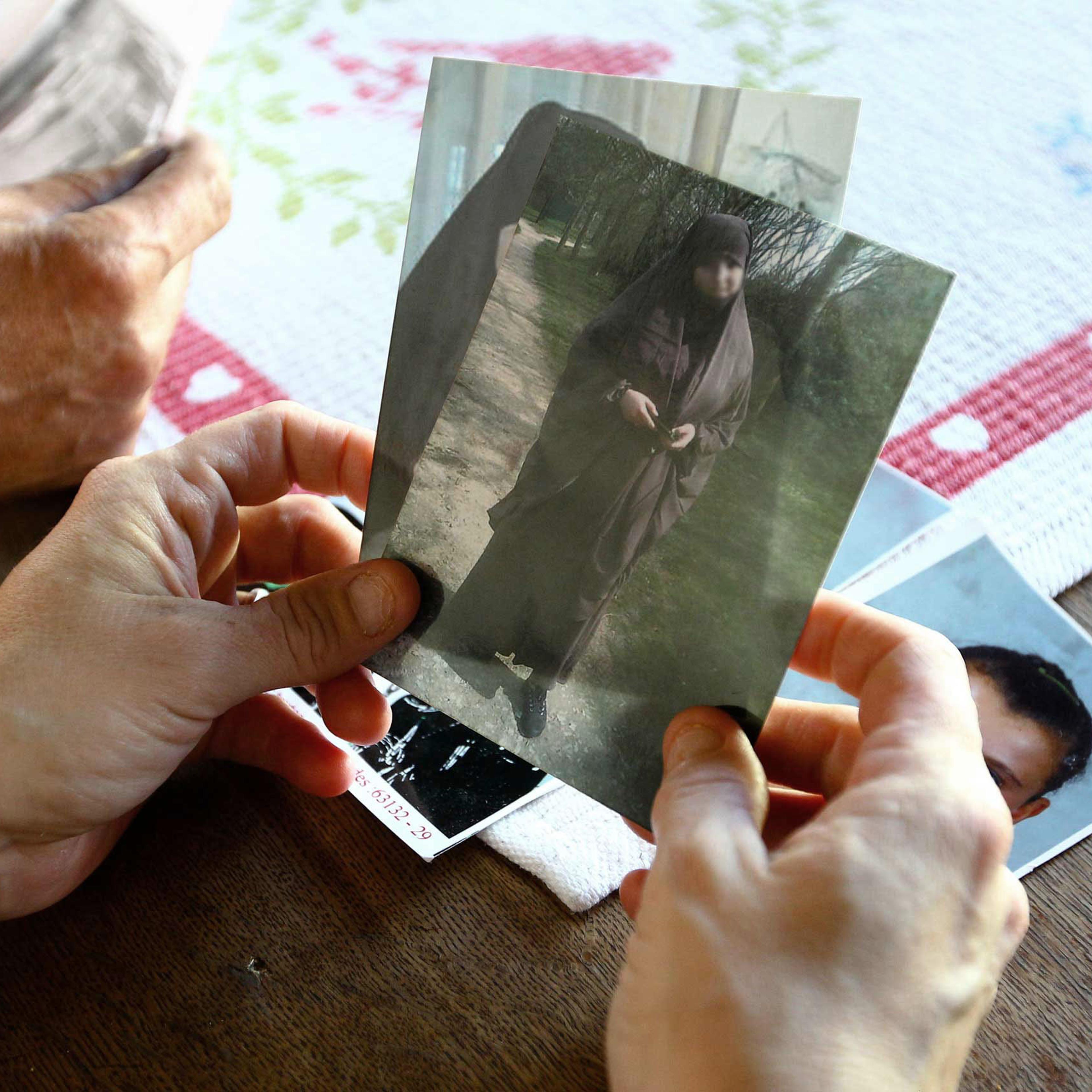 Severine Ali Mehenni holds pictures of her daughter Sahra dressed in a traditional Islamic robe, at her home in Lezignan Corbieres, France, Oct. 2, 2014.