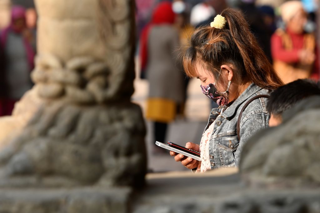 A person looks at their mobile phone.