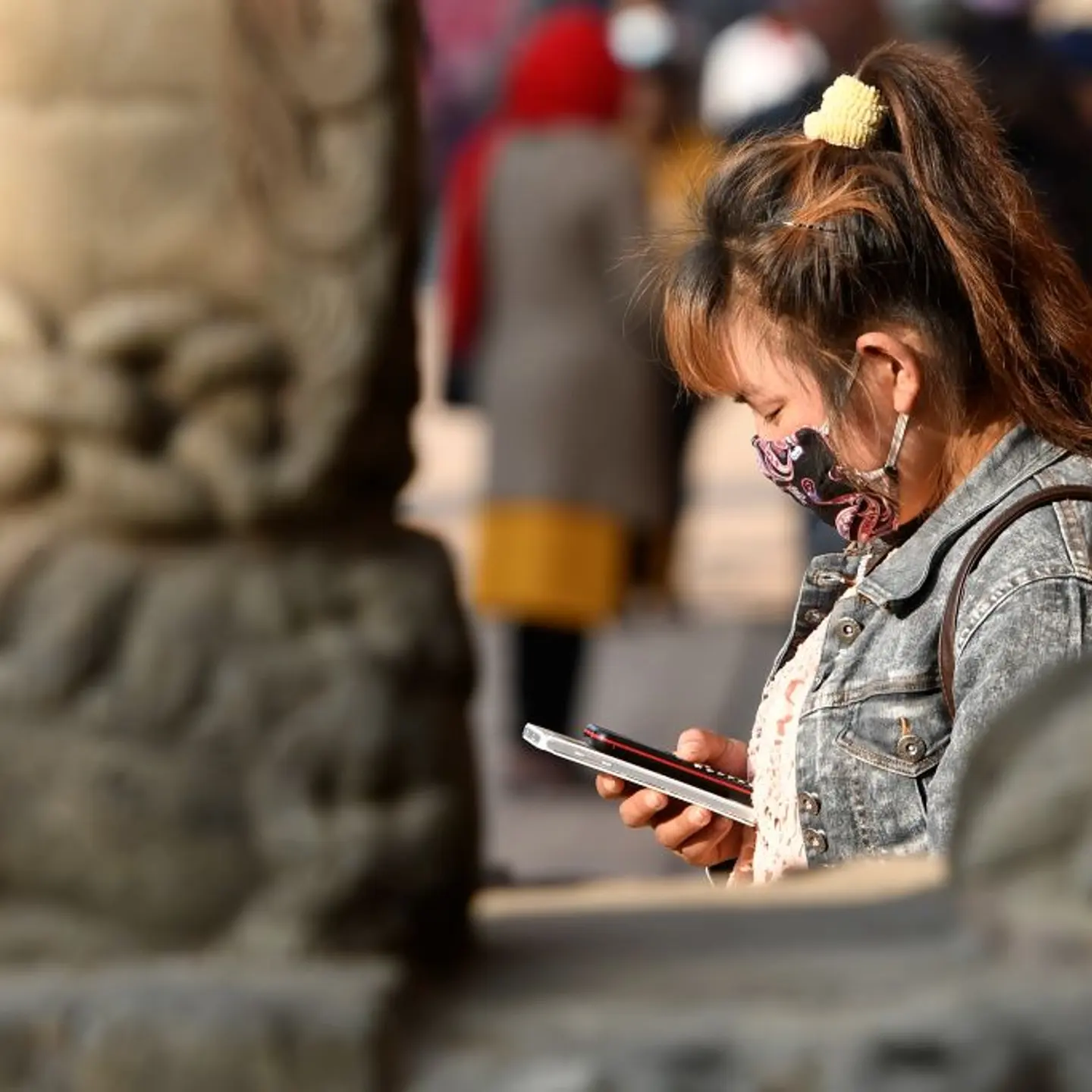 A person looks at their mobile phone.