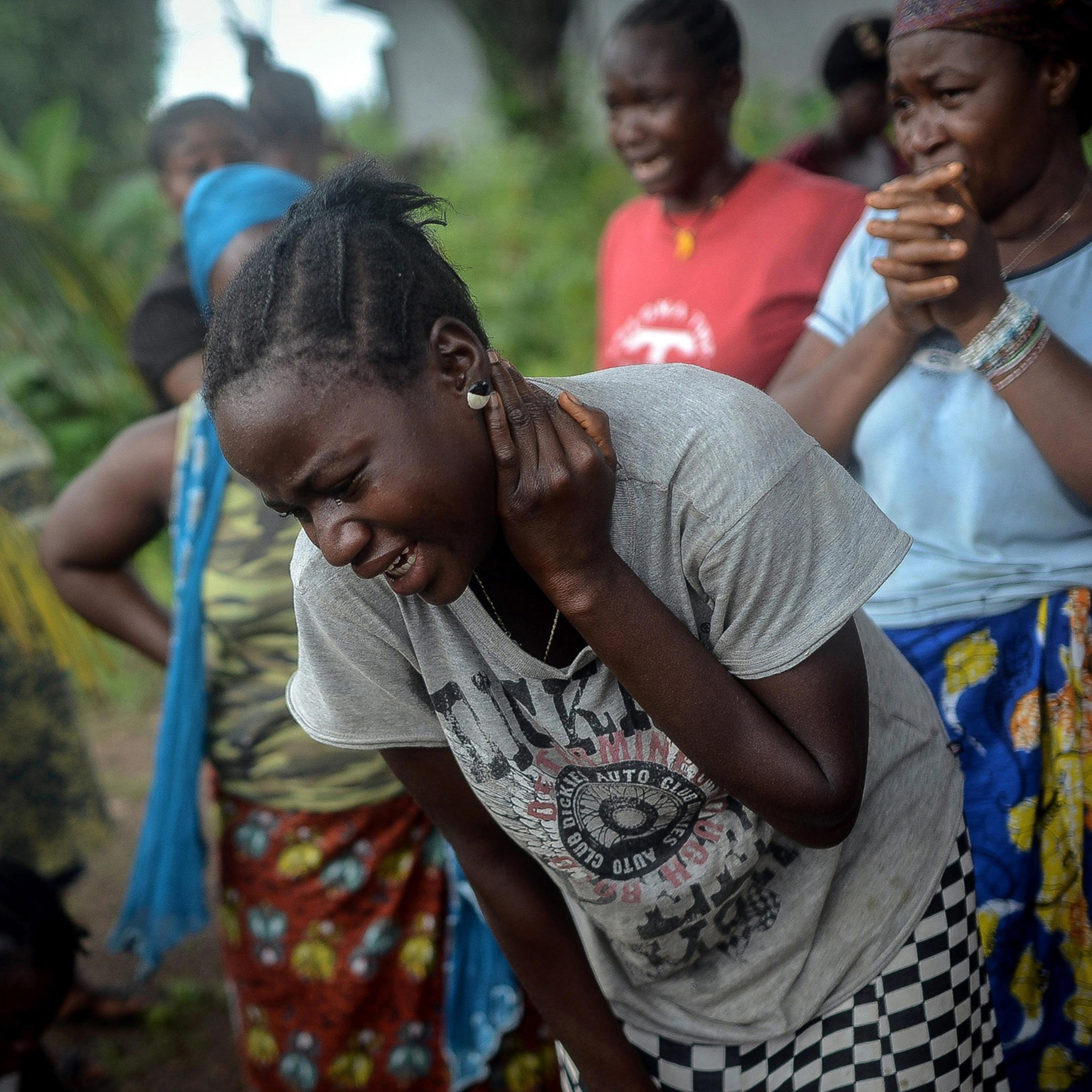 Relatives of an Ebola victim mourn in Lango village, Kenema, Sierra Leone on Aug. 25, 2014.