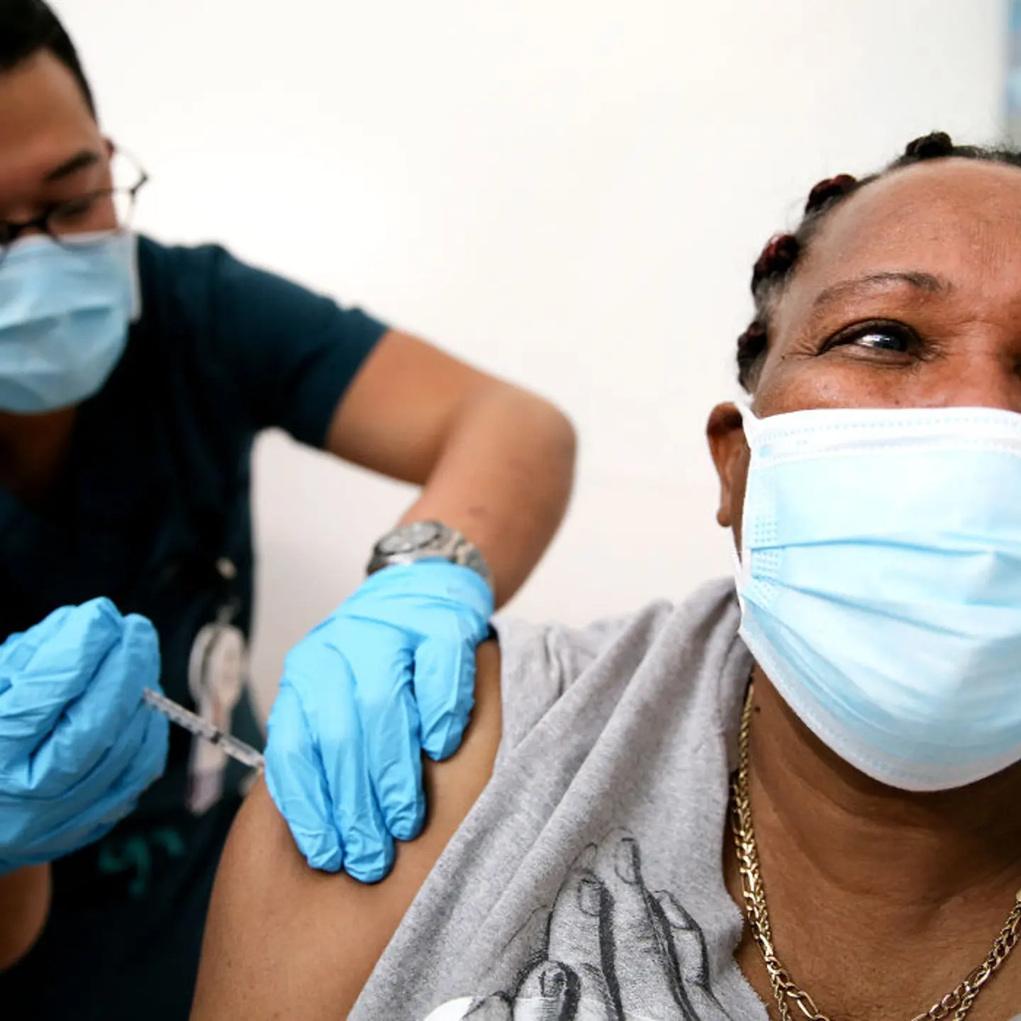 Lorraine Harvey, an in-home care worker, receives her first dose of the COVID-19 vaccine from registered nurse Rudolfo Garcia at a clinic at Martin Luther King Jr. Community Hospital in South Los Angeles on February 25, 2021 in Los Angeles, California.