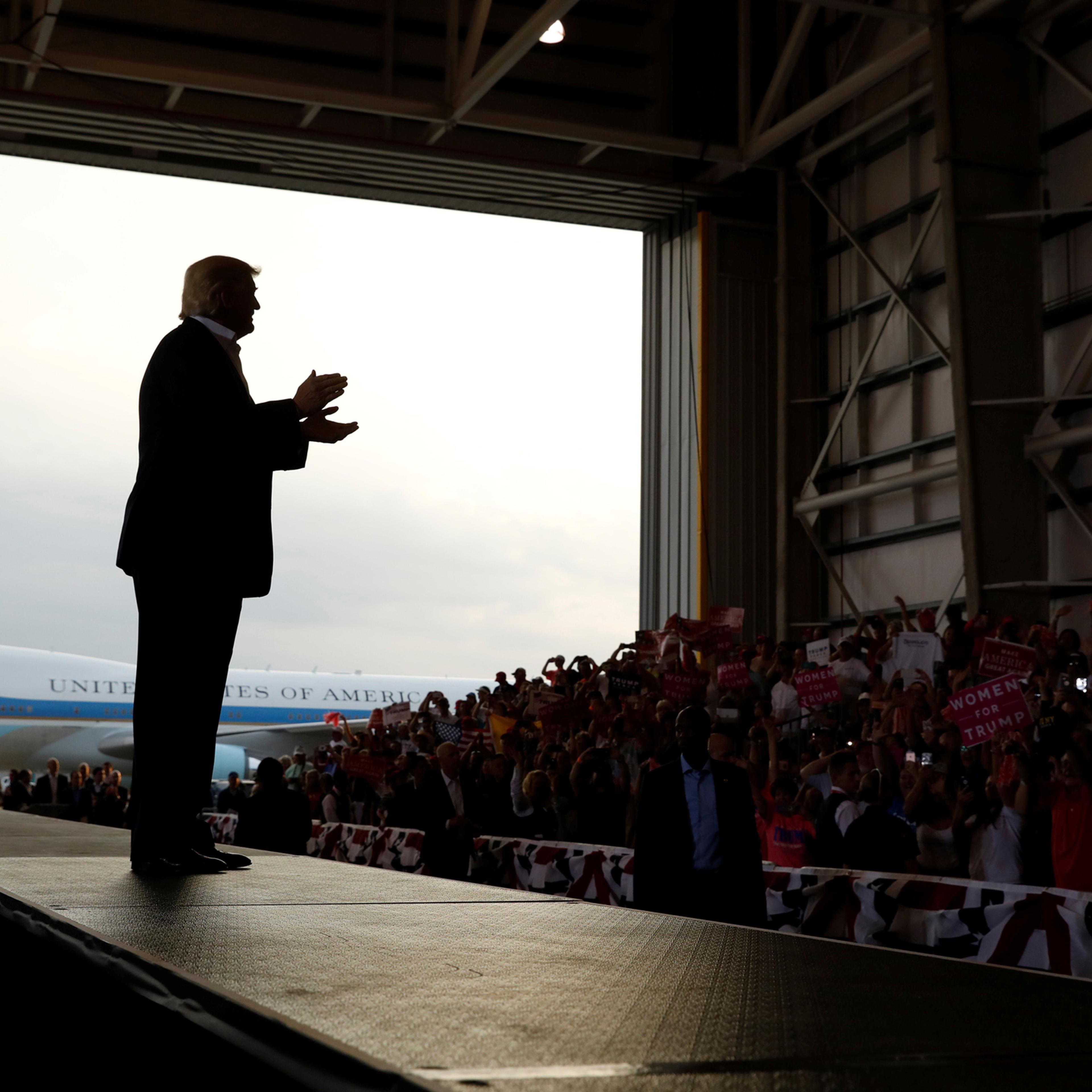 U.S. President Donald Trump applauds his crowd as he holds a "Make America Great Again" rally at Orlando Melbourne International Airport in Melbourne, Florida, U.S. February 18, 2017. REUTERS/Kevin Lamarque TPX IMAGES OF THE DAY - RTSZBI2