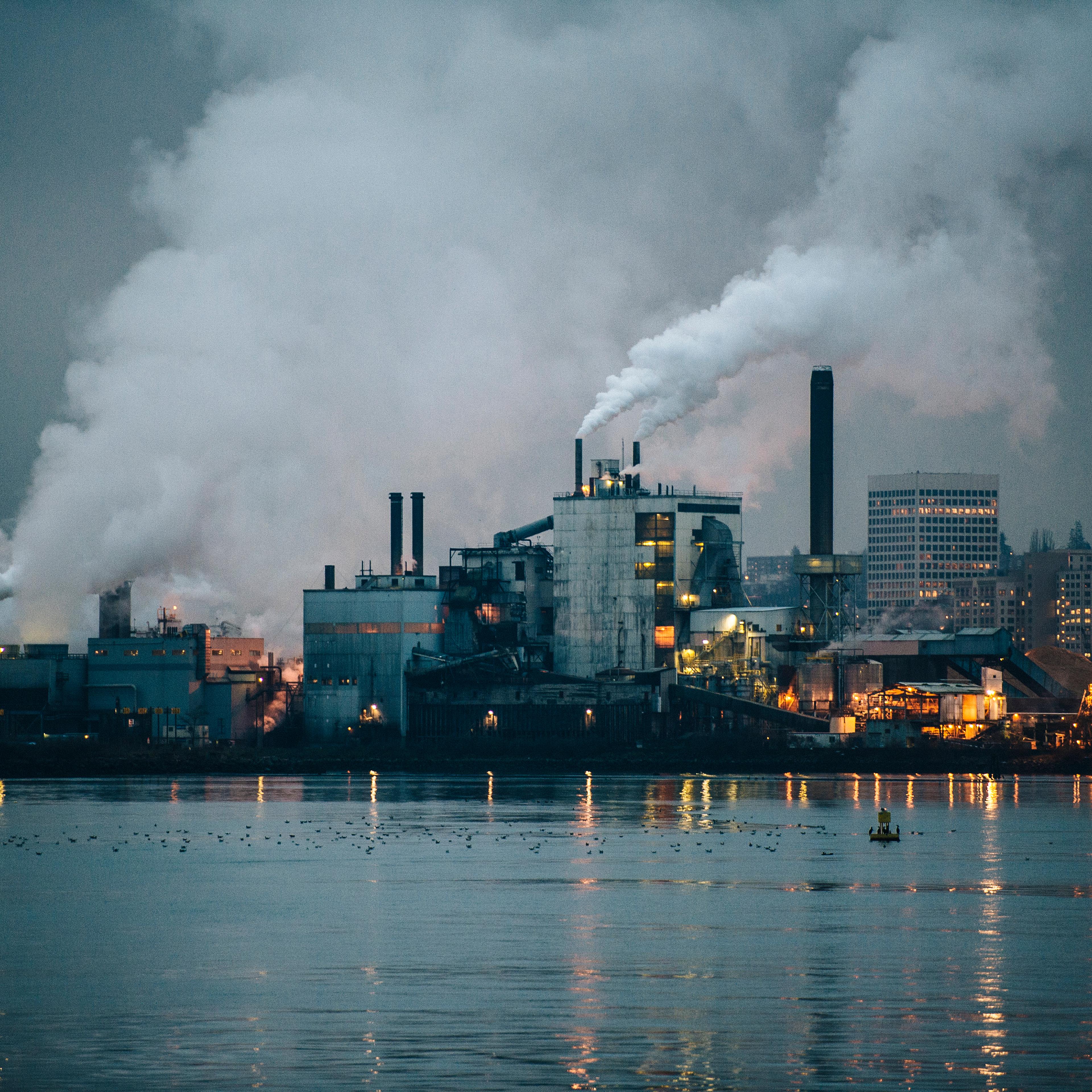 View of industrial plant and smoke stacks at night, Tacoma, Washington, USA