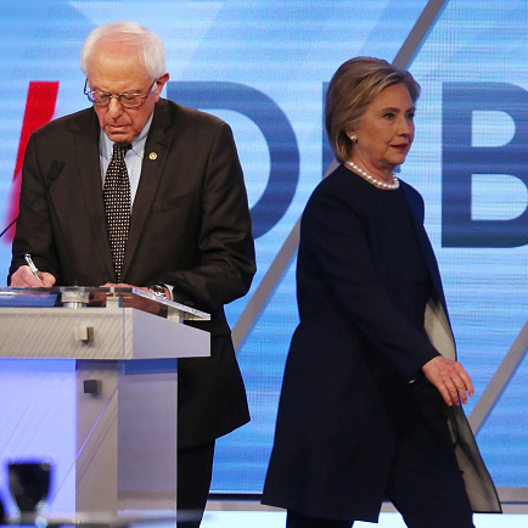 Democratic presidential candidate Senator Bernie Sanders (D-VT) and Democratic presidential candidate Hillary Clinton are seen on stage during a break in the broadcast of the Univision News and Washington Post Democratic Presidential Primary Debate at th