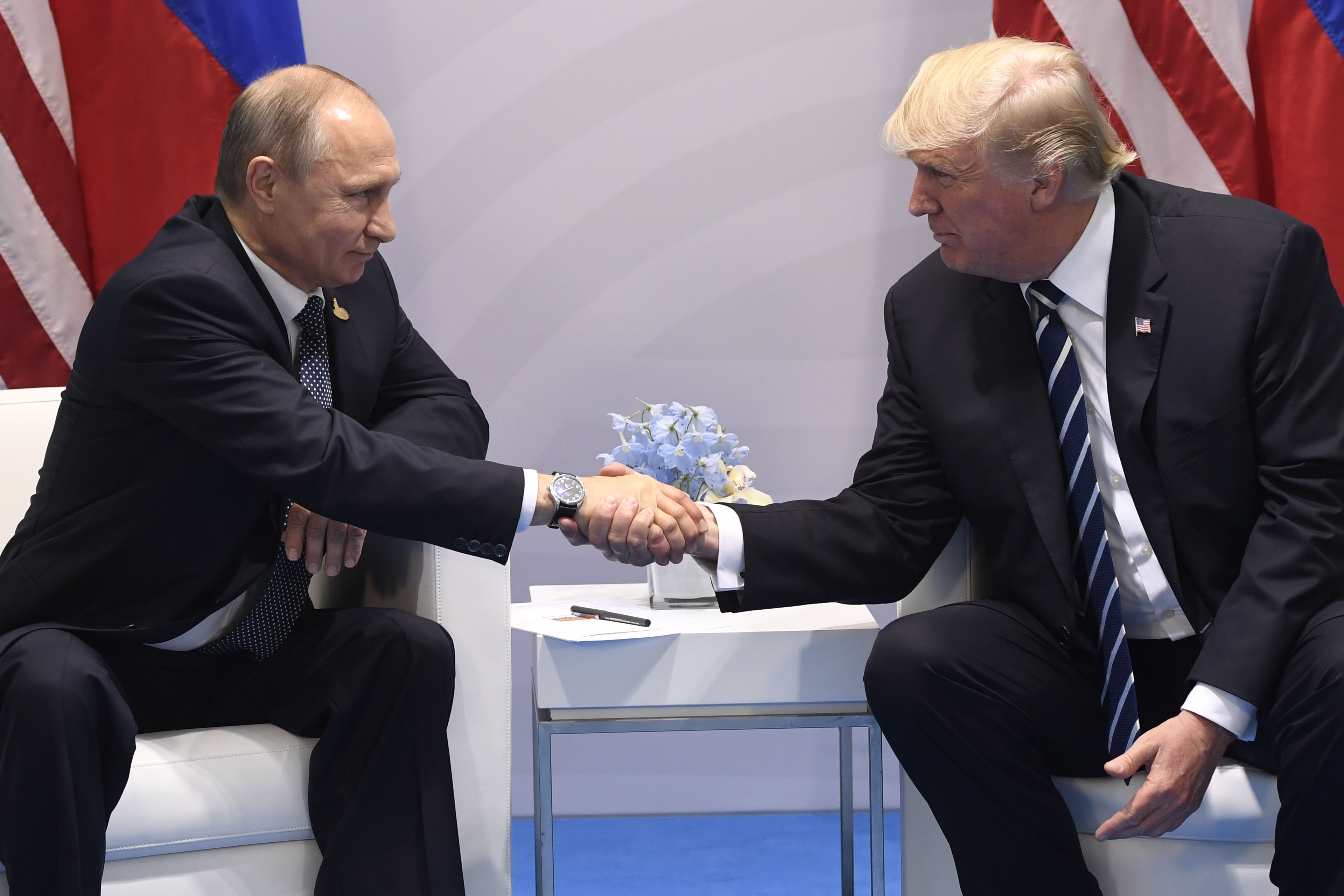 President Donald Trump and Russia's President Vladimir Putin shake hands during a meeting on the sidelines of the G20 Summit in Hamburg, on July 7, 2017.