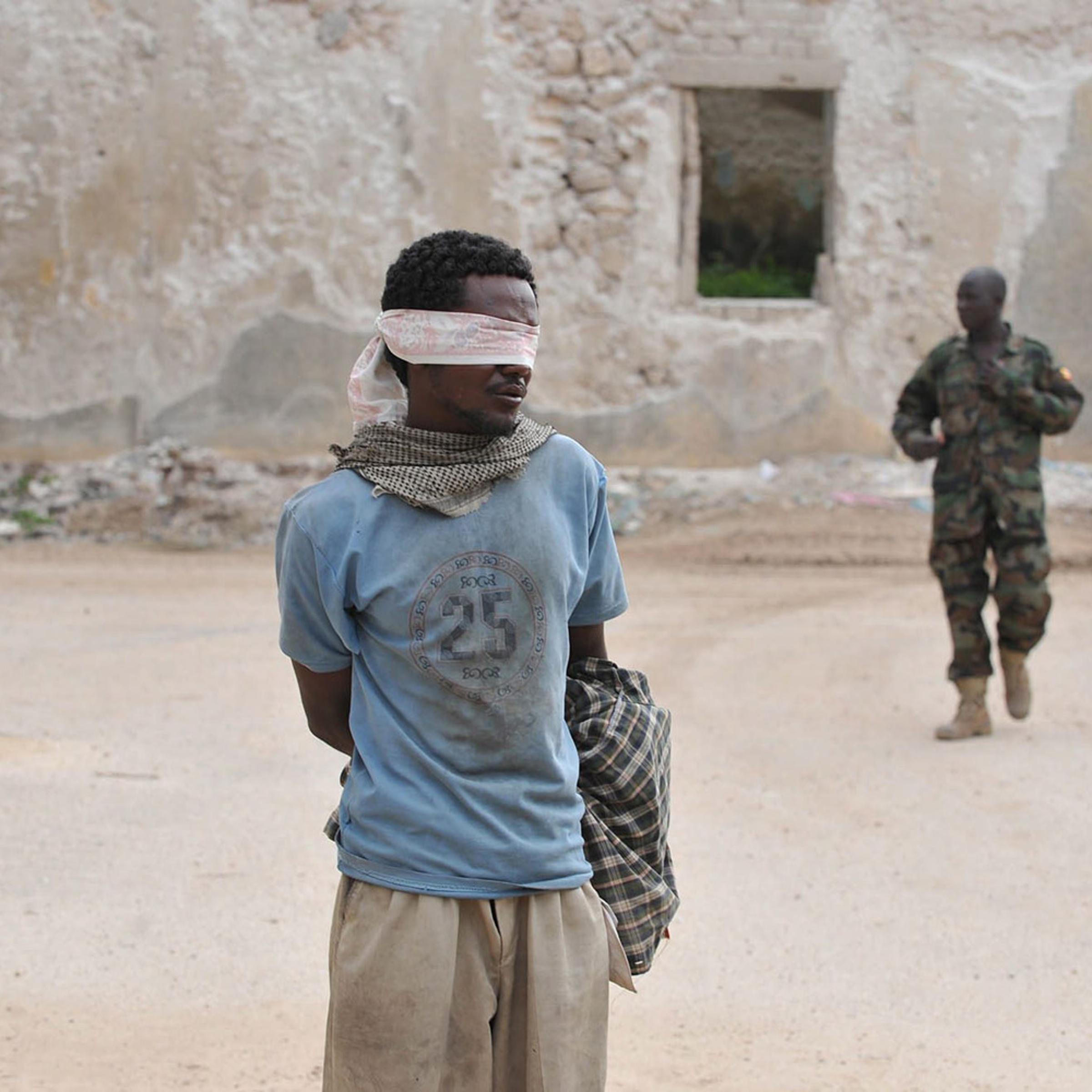 August 6, 2011. A suspected rebel member of Al-Shabab was captured by Amisom (African mission in Somalia) in Mogadishu shortly after the militant group withdrew from the last four districts that they held after heavy fighting through out the night, Somalia. Reports state that the conflict has hindered aid efforts in the famine-hit country, with the militia barring some aid agencies from central and southern areas it controls.