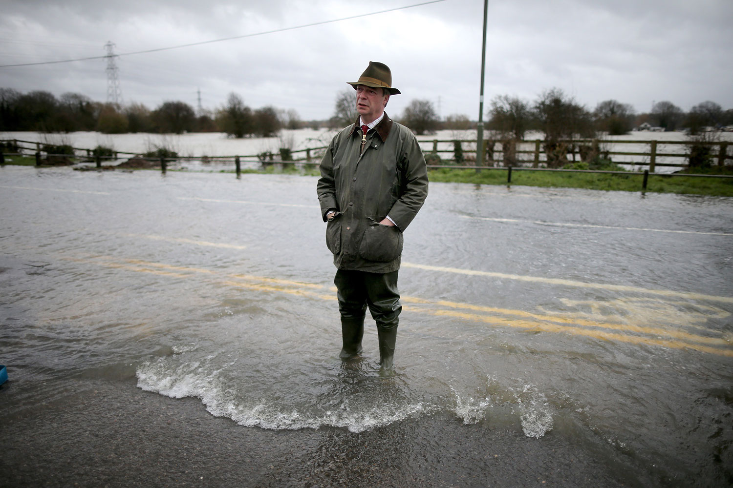 Leader of UKIP Nigel Farage tours flooded properties and roads as he visits Chertsey on Feb. 11, 2014 in Chertsey, United Kingdom.