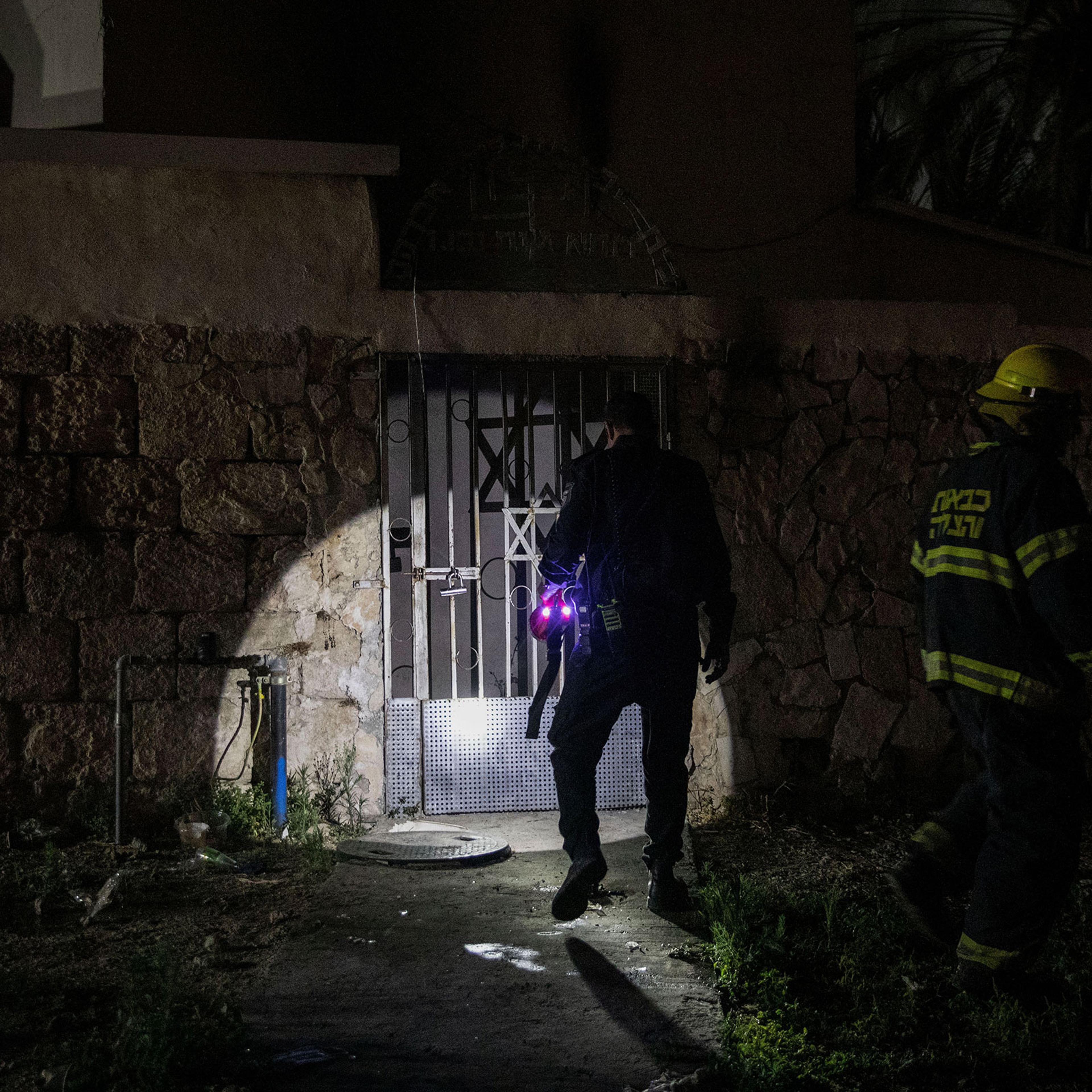 Firefighters inspect a synagogue that was set on fire during violent clashes in the mixed Arab-Jewish city of Lod, Israel, on May 14, 2021.