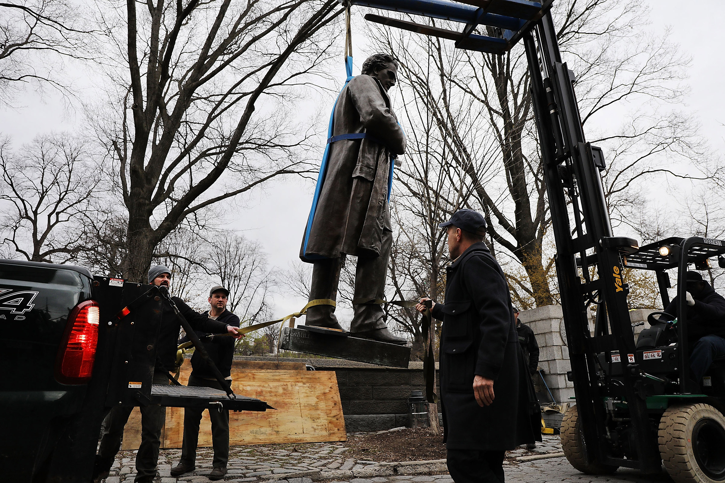 A statue of J. Marion Sims, who was a prominent gynecologist, is loaded onto a New York City Department of Parks &amp; Recreation truck after being taken down from its pedestal bordering Central Park on East 103rd Street on April 17, 2018.