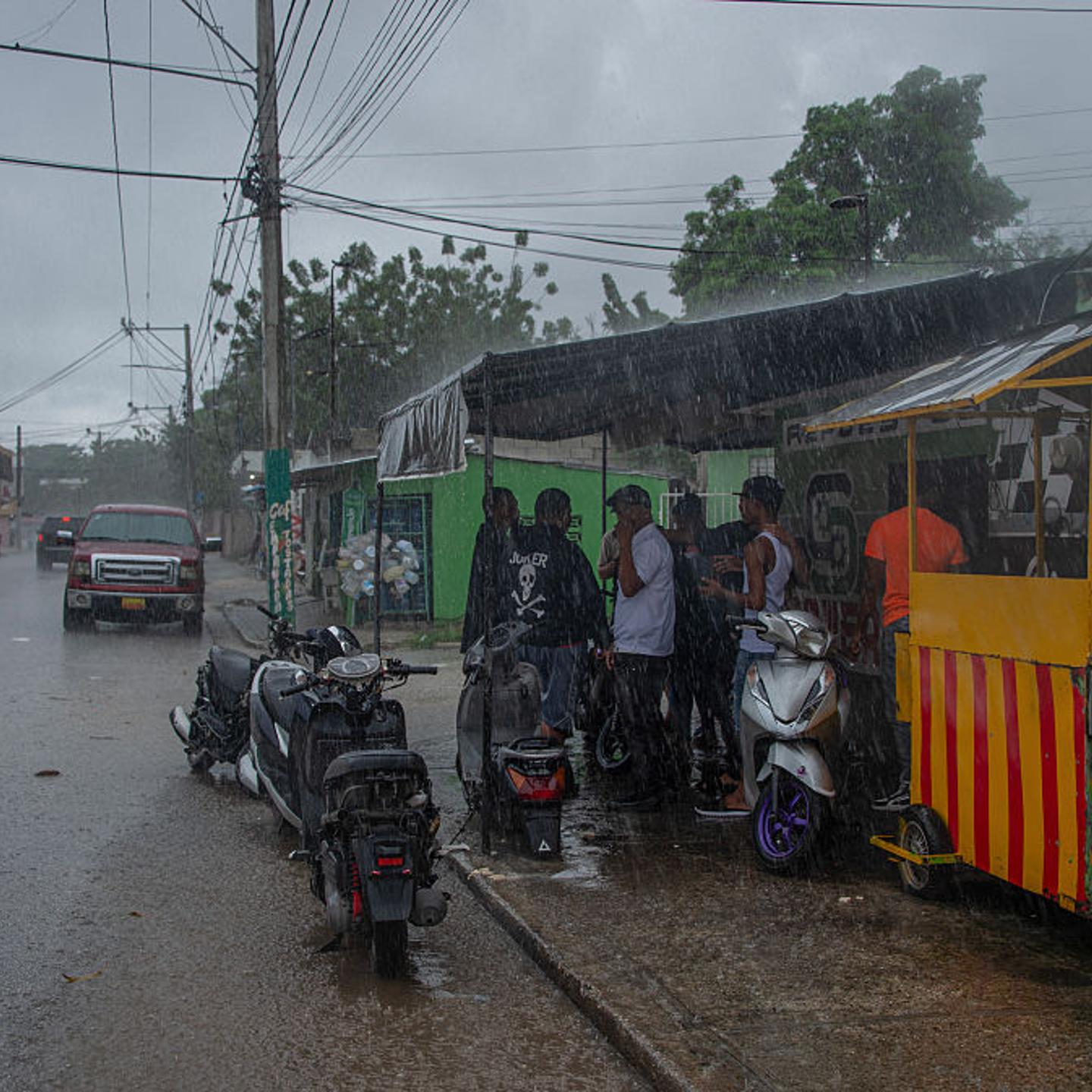 People take cover from the rain after the passing of the tropical storm Melissa before becoming a hurricane in Barahona, Dominican Republic on Oct. 28, 2025.