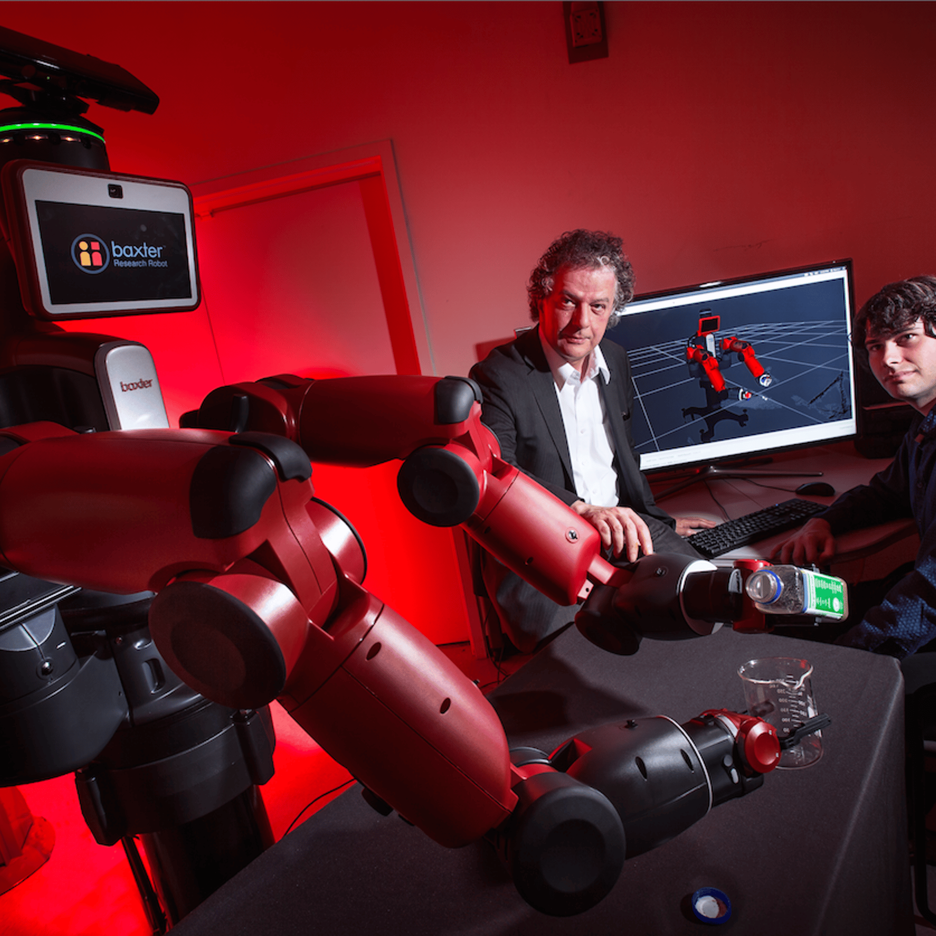 University of Maryland computer scientist Yiannis Aloimonos (center) is shown with Julia, a robot that learned to make salad by watching YouTube videos.