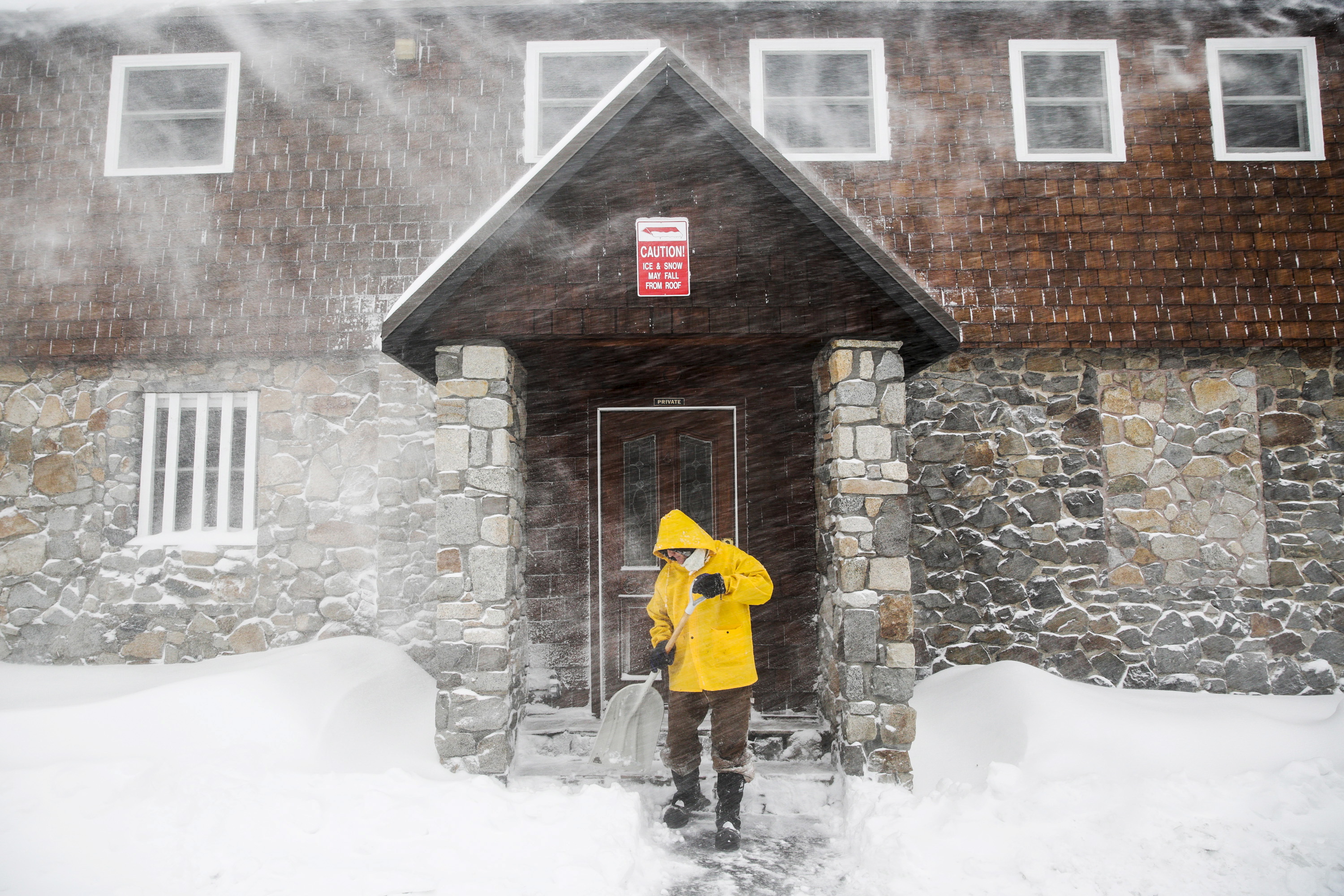 Craig Bentley, caretaker of Soda Springs Station, shovels snow in Soda Springs
