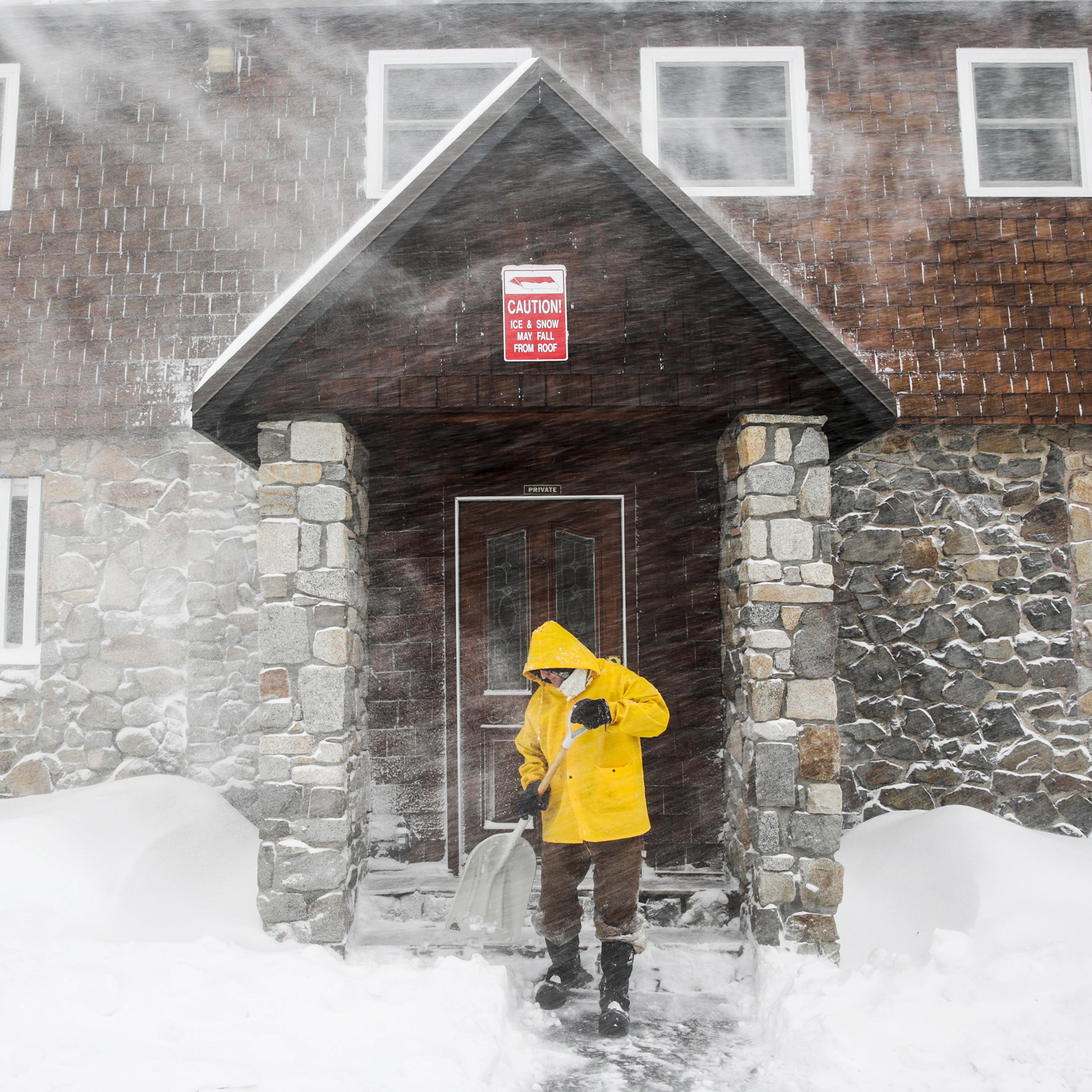 Craig Bentley, caretaker of Soda Springs Station, shovels snow in Soda Springs