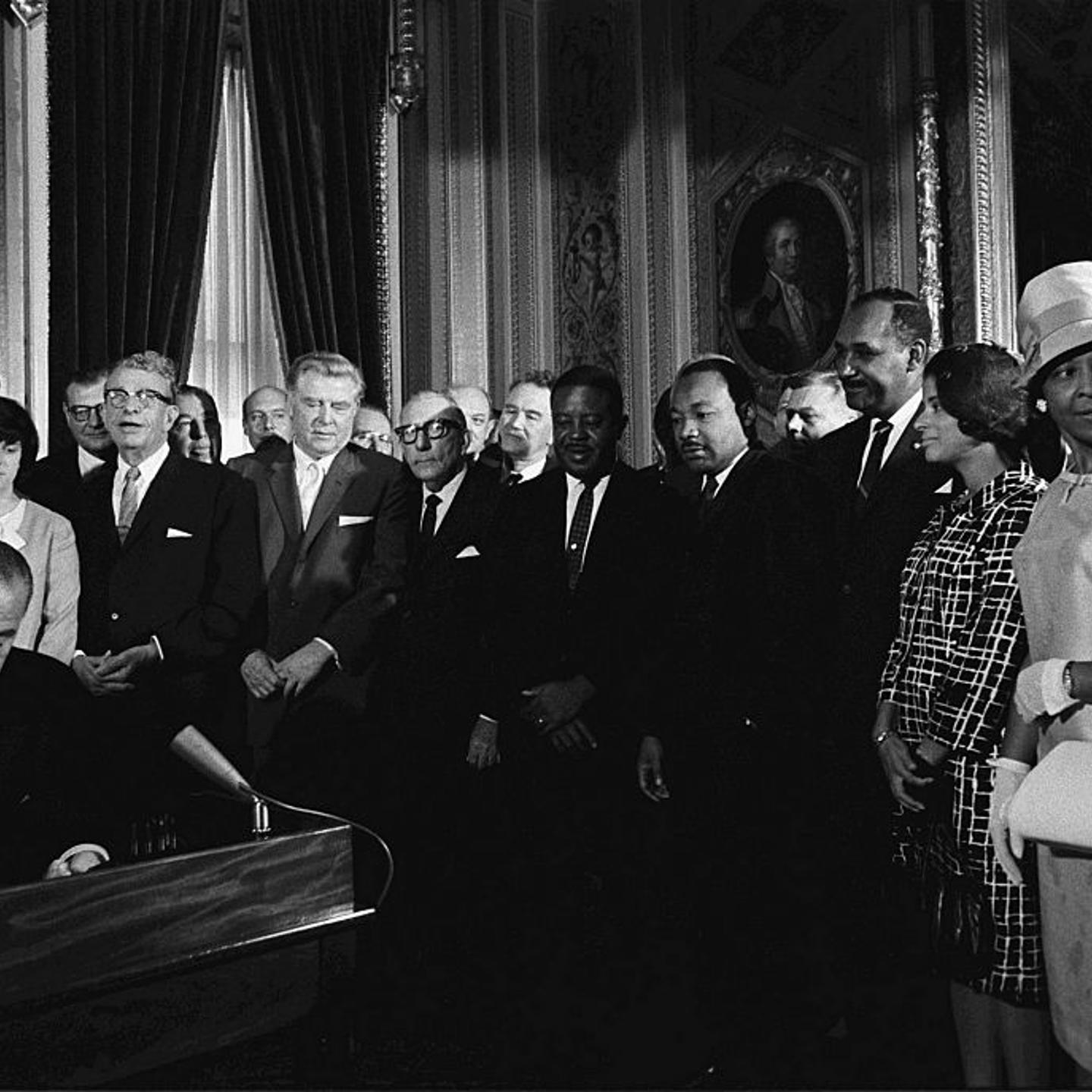 President Lyndon B. Johnson signs the Voting Rights Act of 1965, Martin Luther King looks on