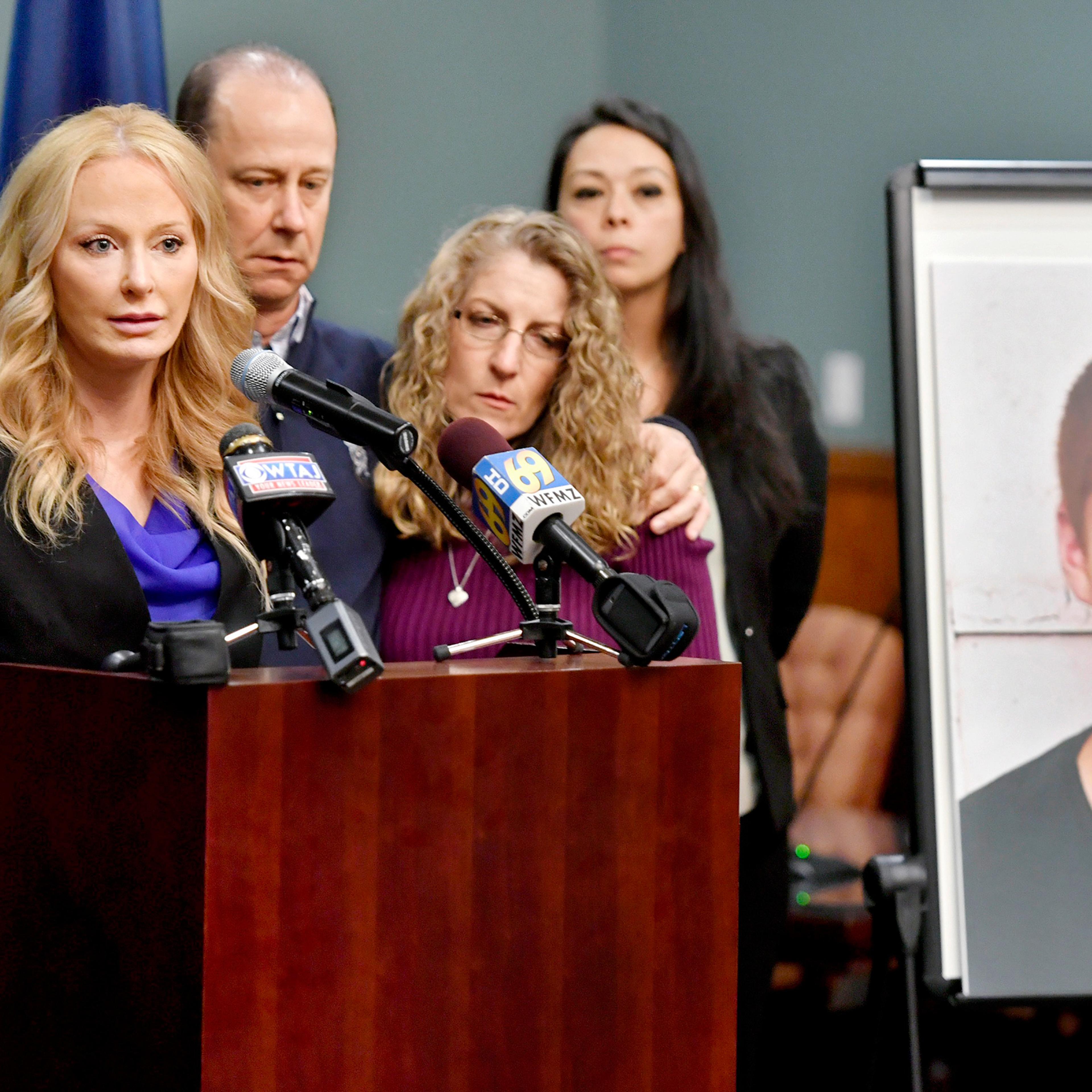 Centre County District Attorney Stacy Parks Miller, left, stands with Tim Piazza’s parents on May 5 to announce the results of an investigation into his death