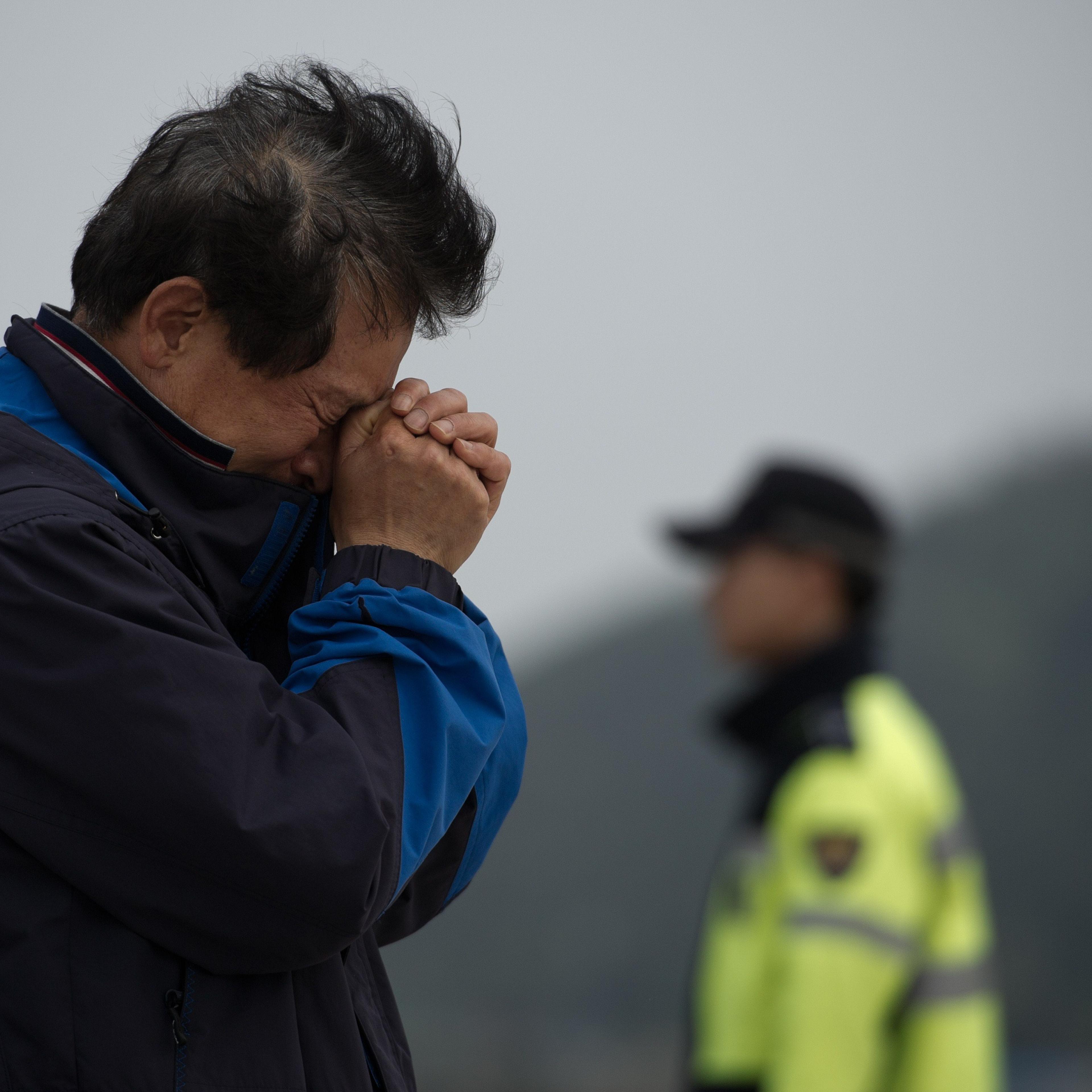 A relative weeps at an area where family members of victims of the South Korean ferry 'Sewol' are gathered, at Jindo harbour on April 21, 2014.