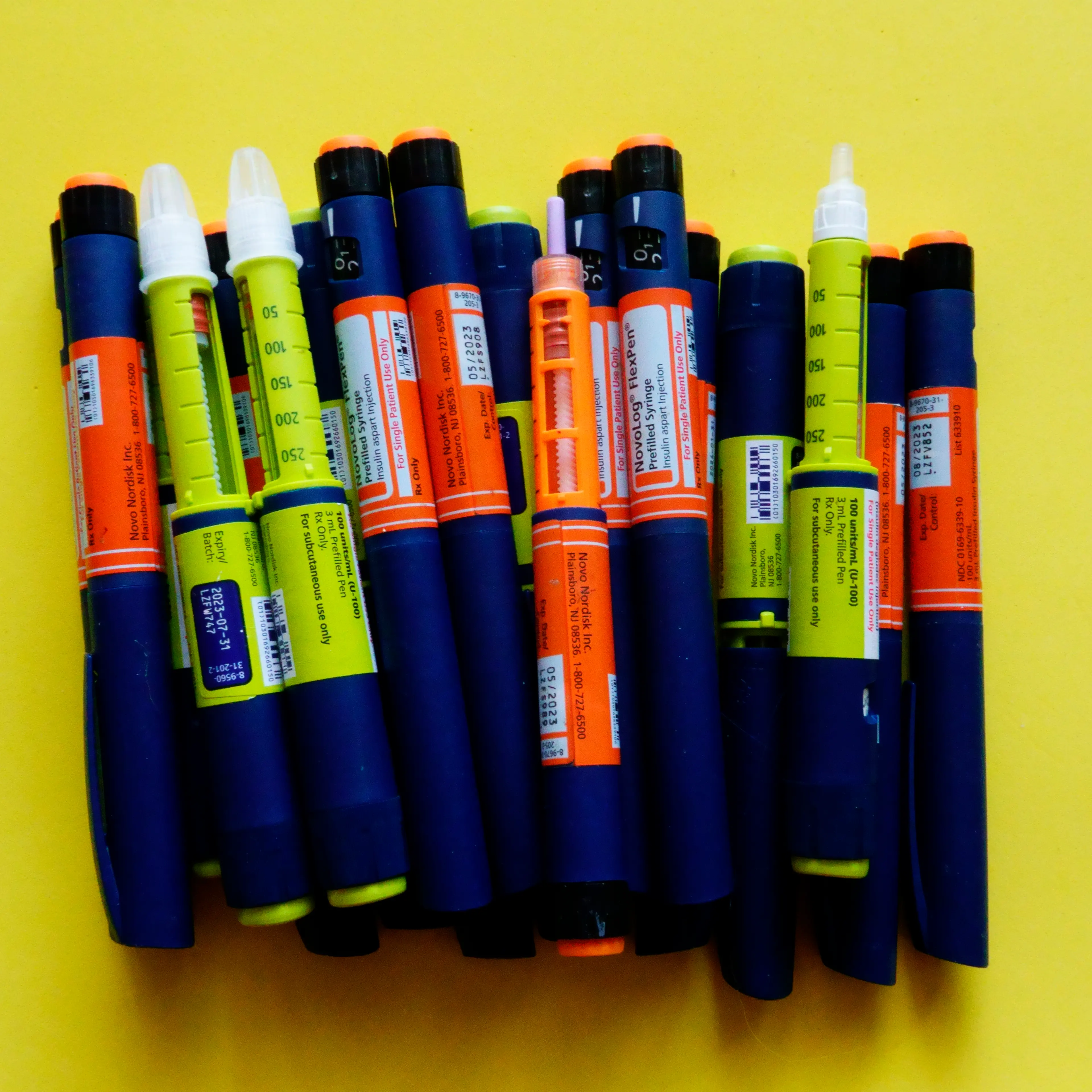 Still life of Tresiba insulin pens on yellow