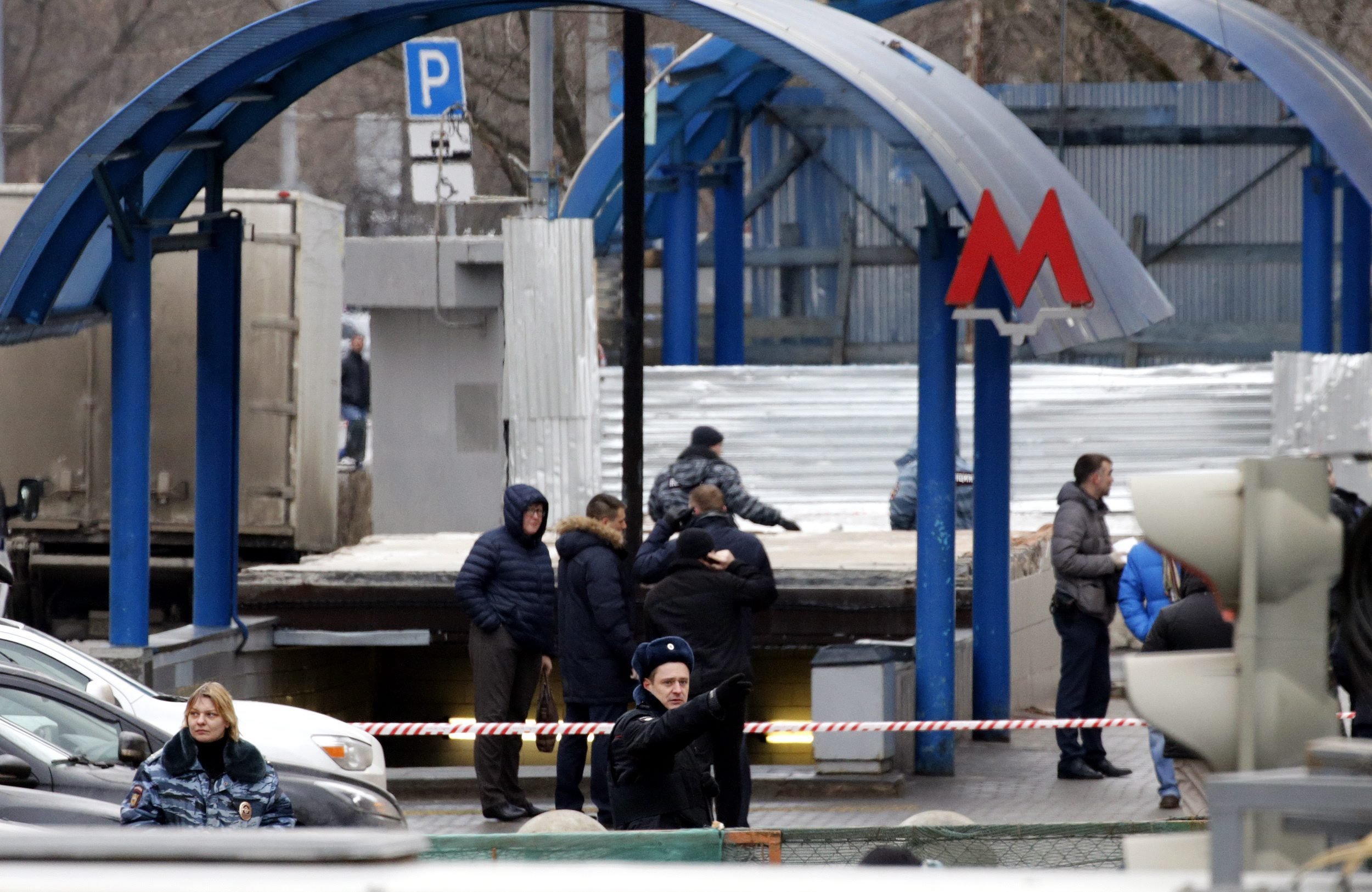 Investigators and police inspect the site near the Oktyabrskoye Pole underground station where a woman carrying a severed child's head was arrested in Moscow, Russia on Feb. 29 2016.