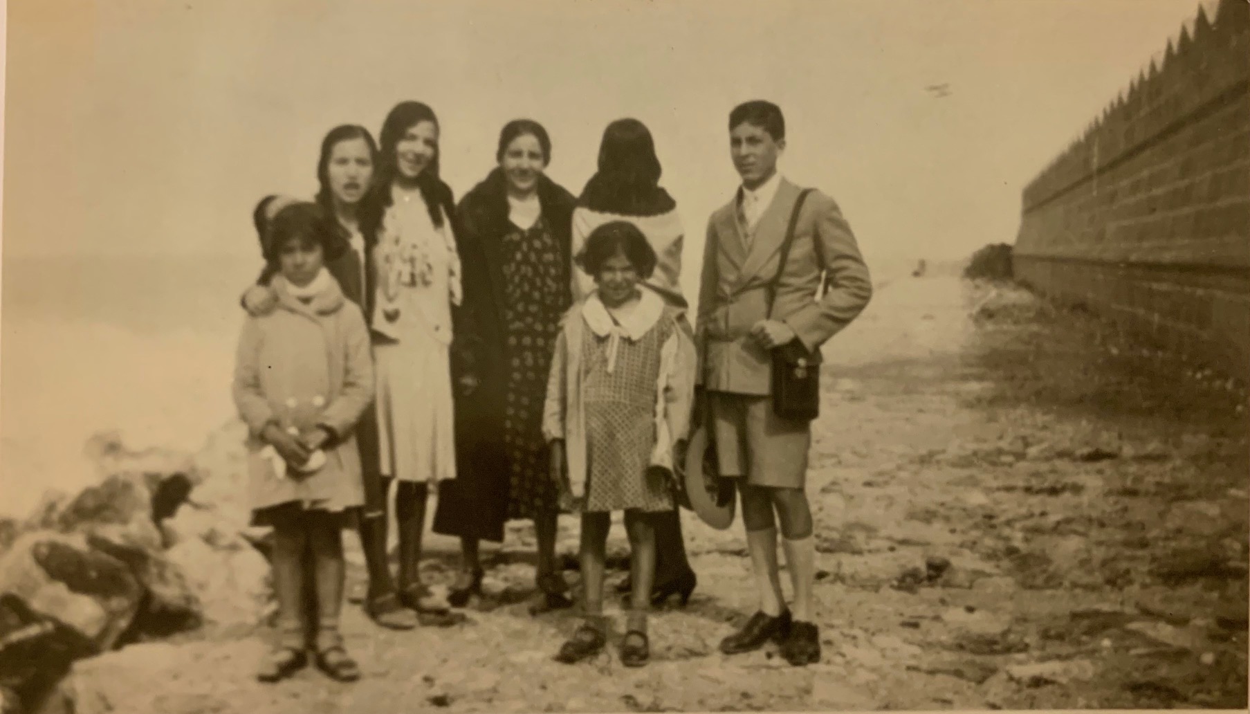 Stella Levi (front right, with her coat open) photographed with family and friends outside the city walls of Rhodes, c. 1928.
