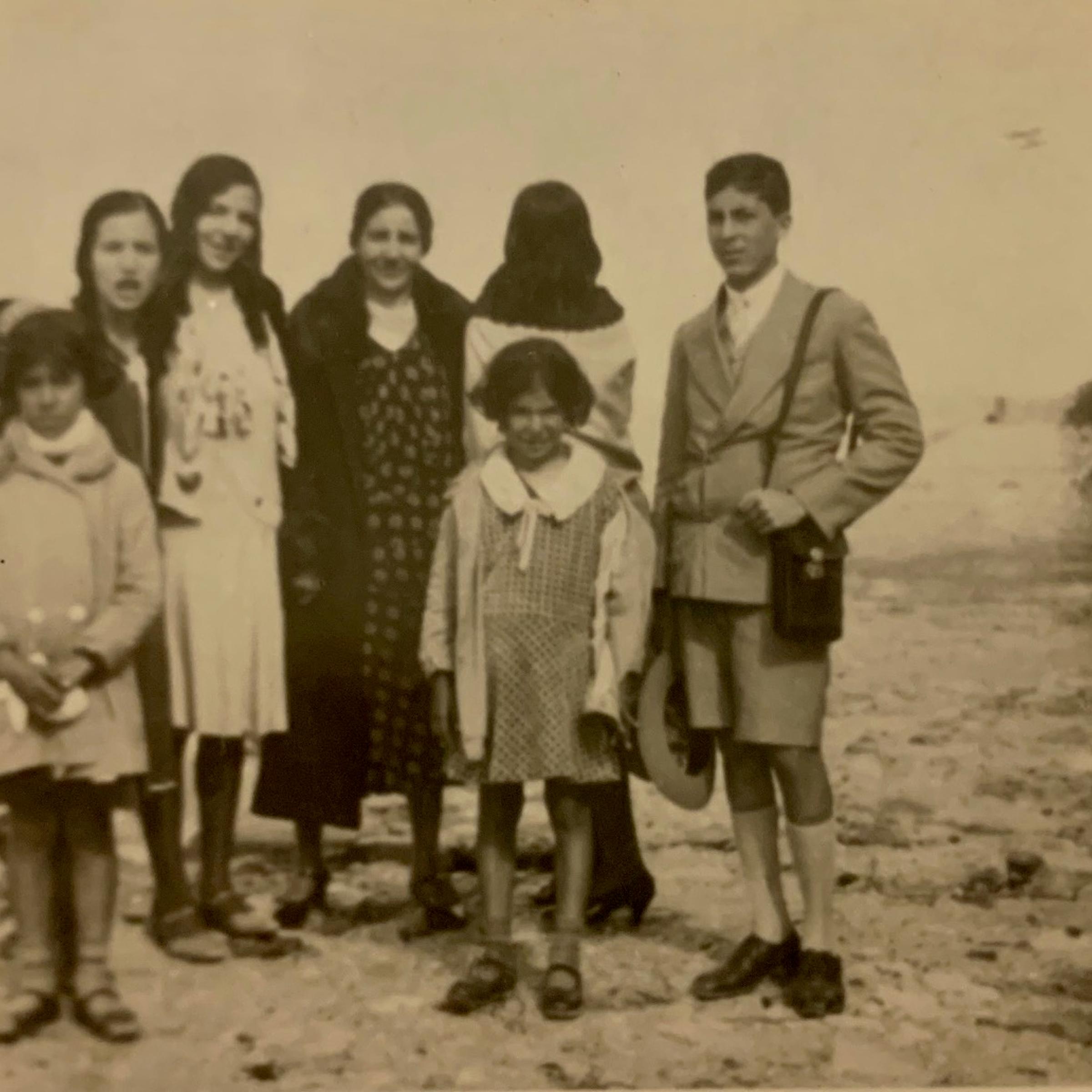 Stella Levi (front right, with her coat open) photographed with family and friends outside the city walls of Rhodes, c. 1928.