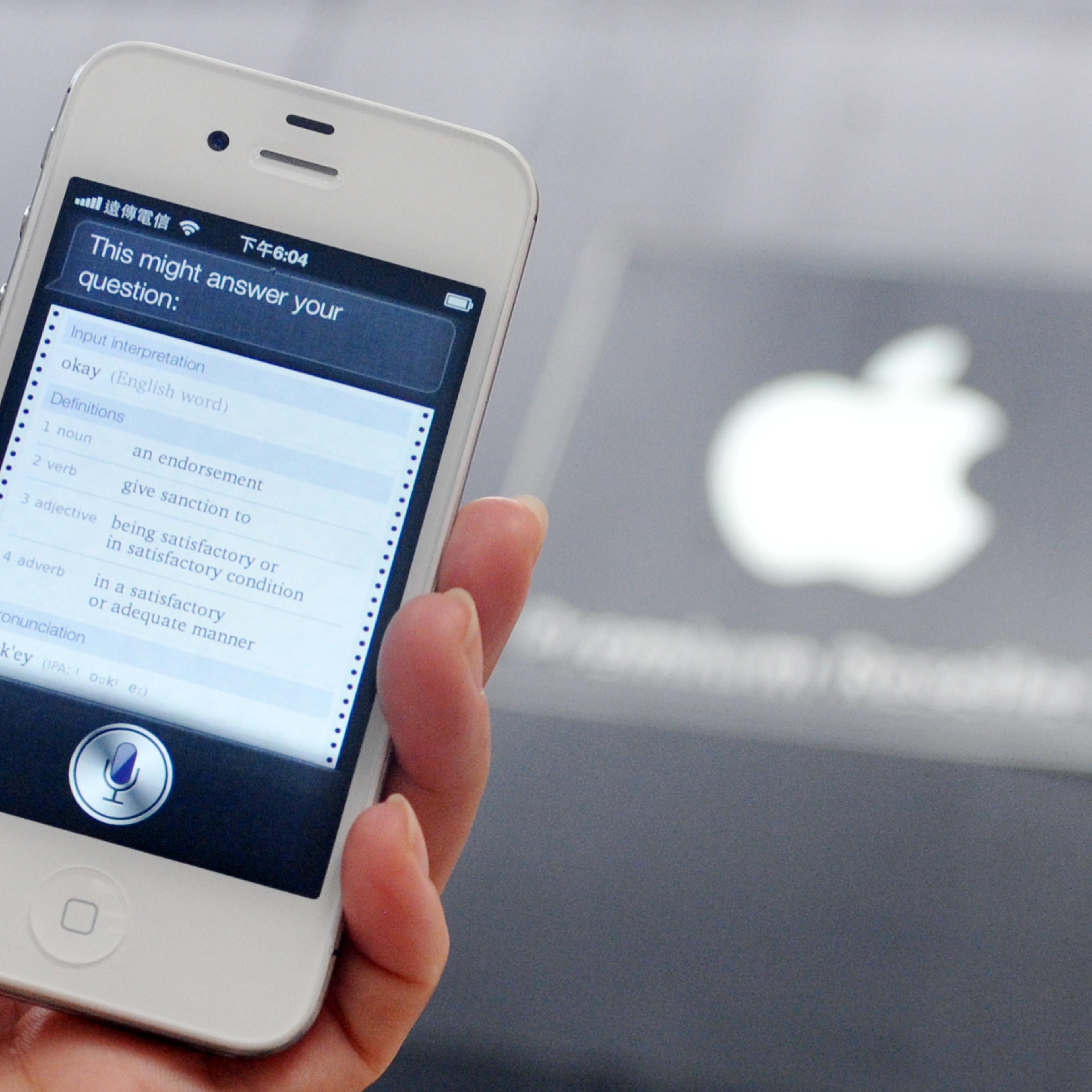 A woman displays "Siri", voice-activated assistant technology, on an Apple iPhone 4S in Taipei on July 30, 2012.