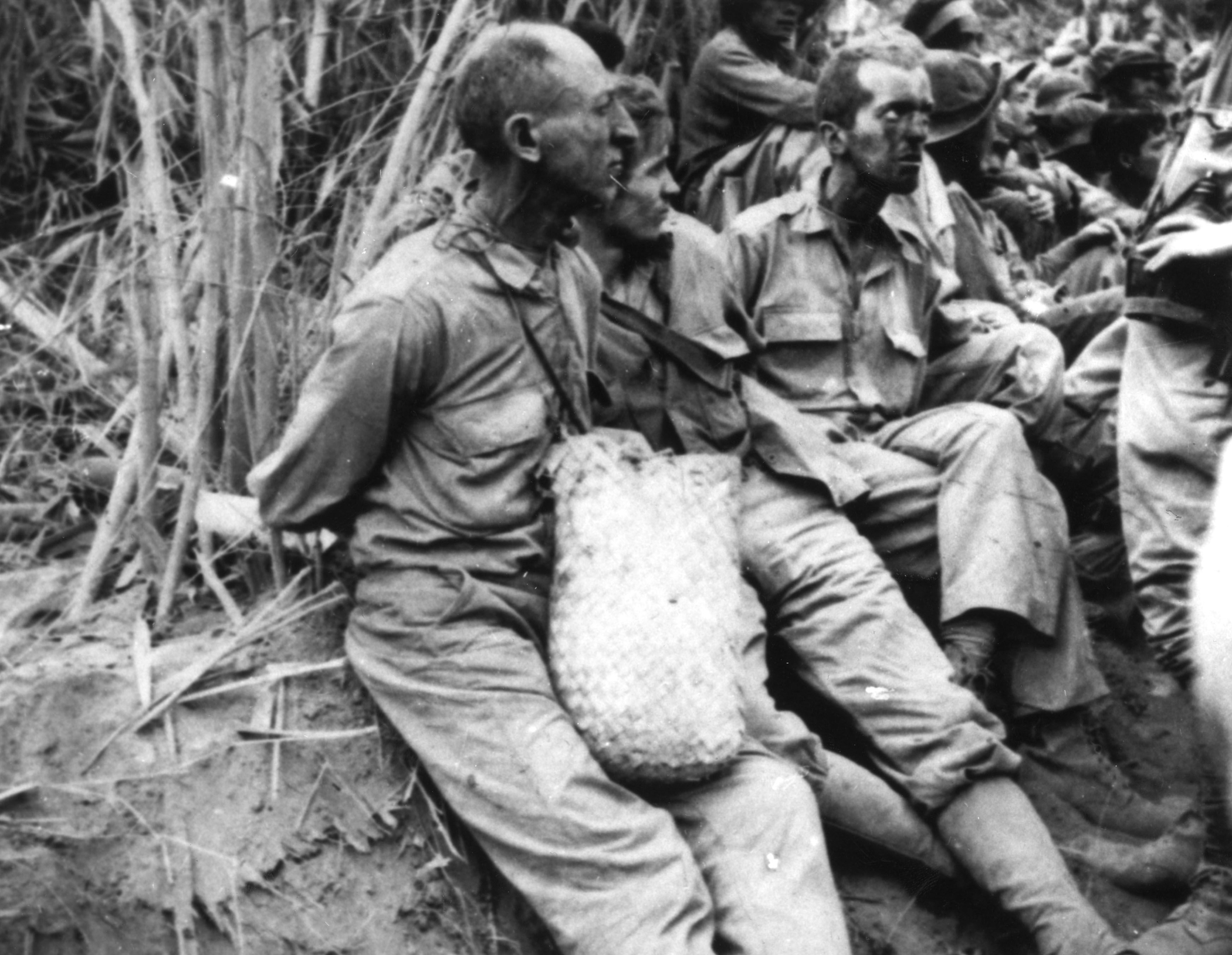 American and Filipino prisoners of war during the Bataan Death march when the Japanese force-marched them across the Philippines, May 1942.
